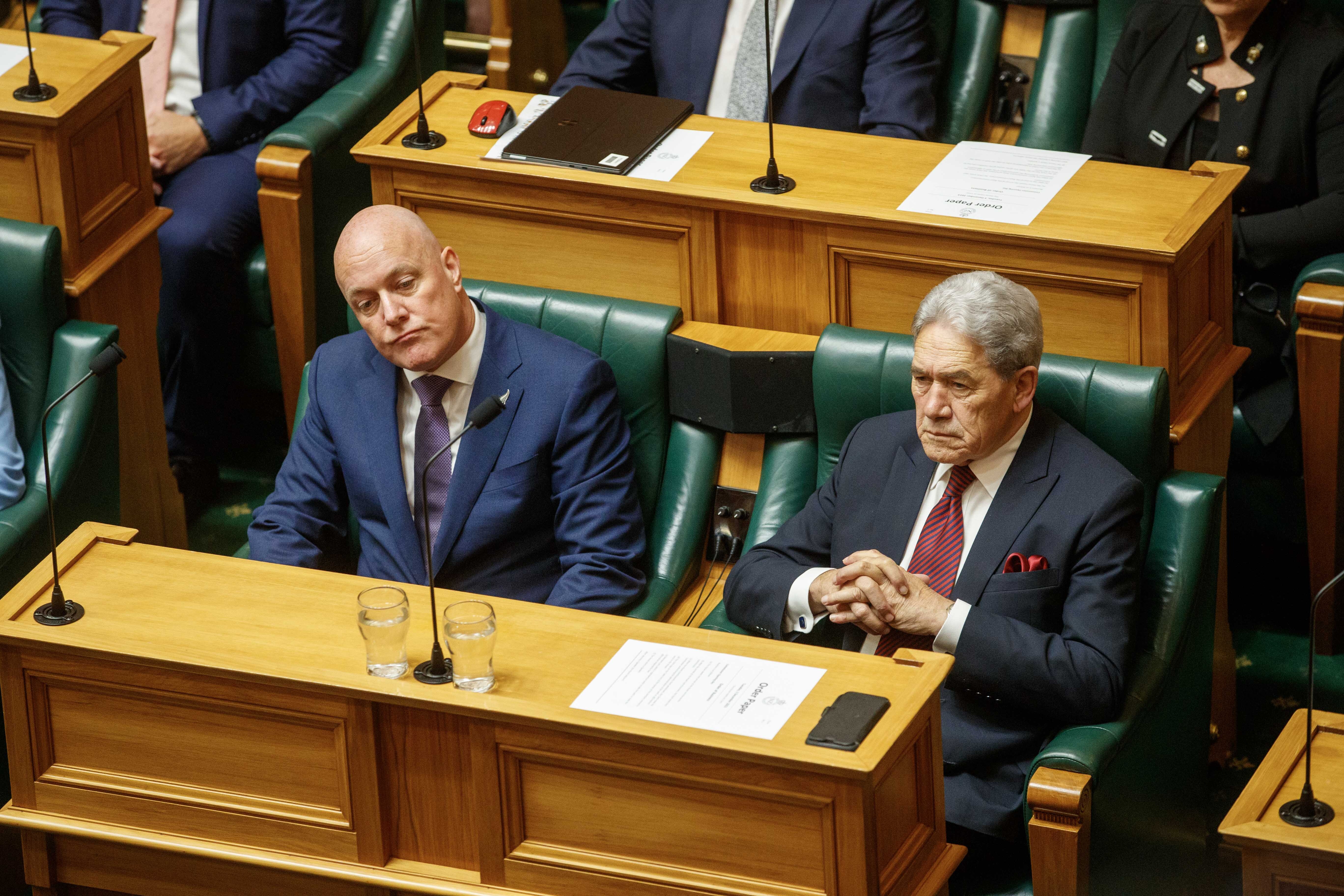 Prime Minister Christopher Luxon and Deputy Prime Minister Winston Peters watch on as the swearing-in ceremony continues in the House. Photo / Mark Mitchell
