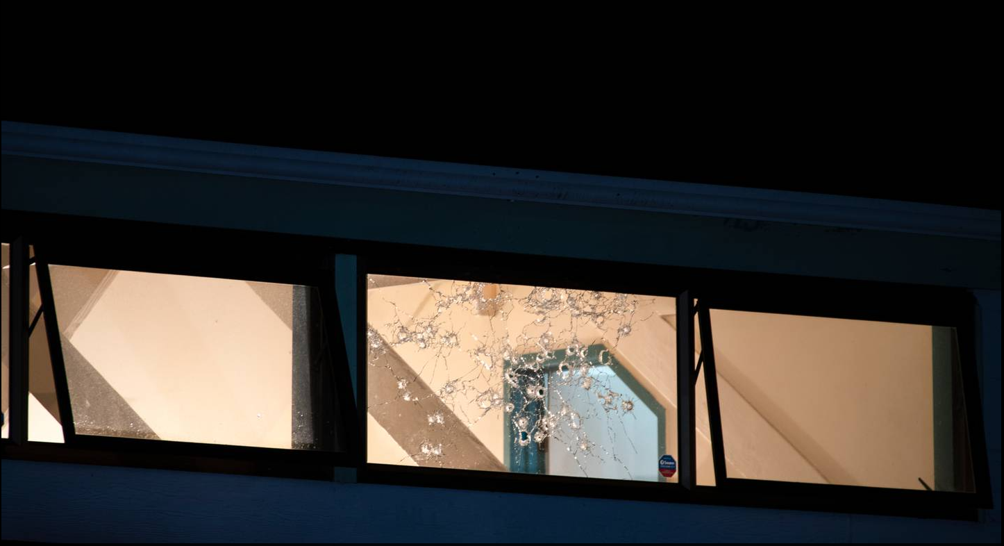 A window riddled with bullet holes at a house in Papatoetoe. Photo / Hayden Woodward