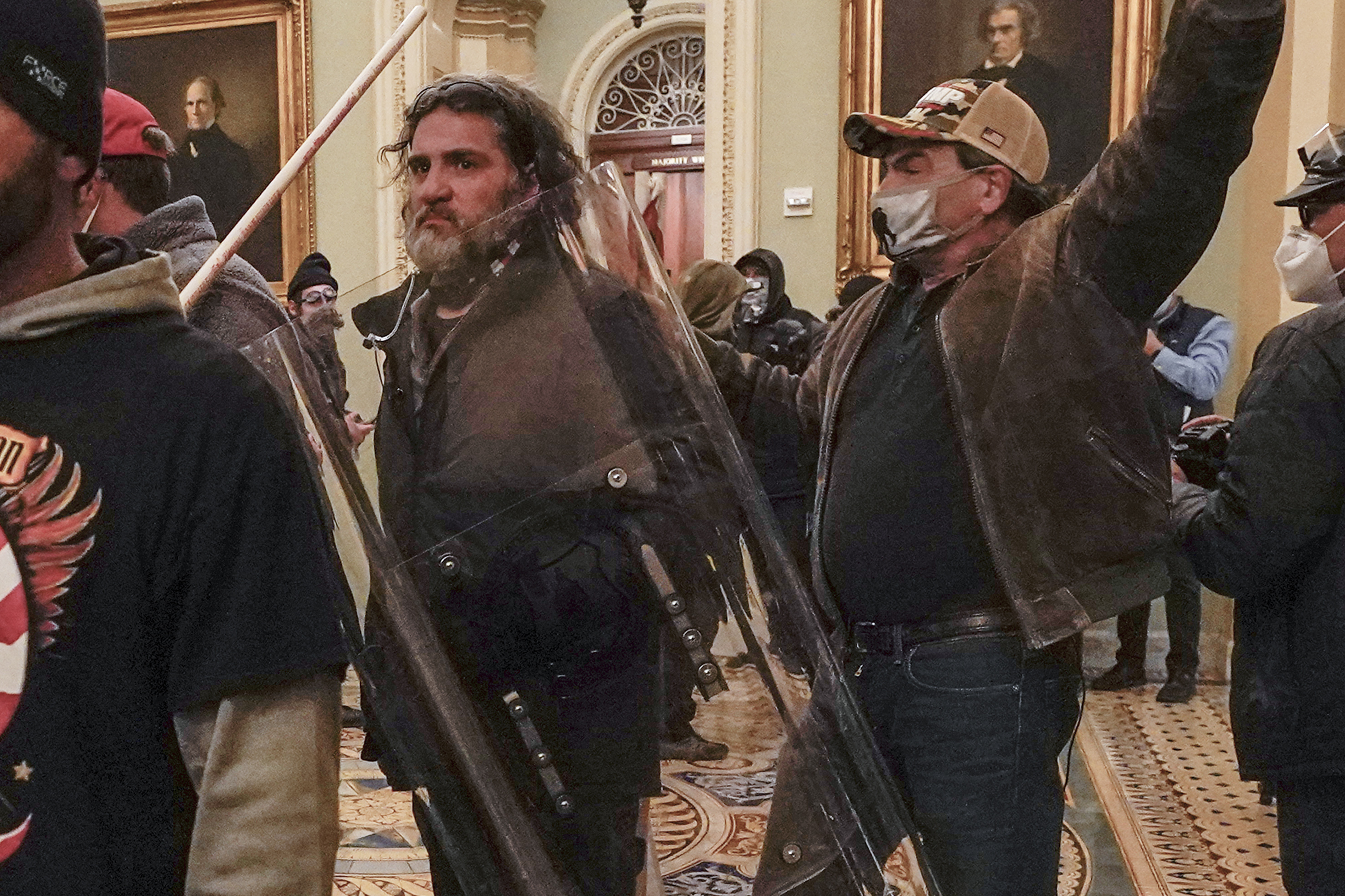 Rioters, including Dominic Pezzola, centre with police shield, are confronted by US Capitol Police officers outside the Senate Chamber. Photo / Manuel Balce Ceneta, AP, File