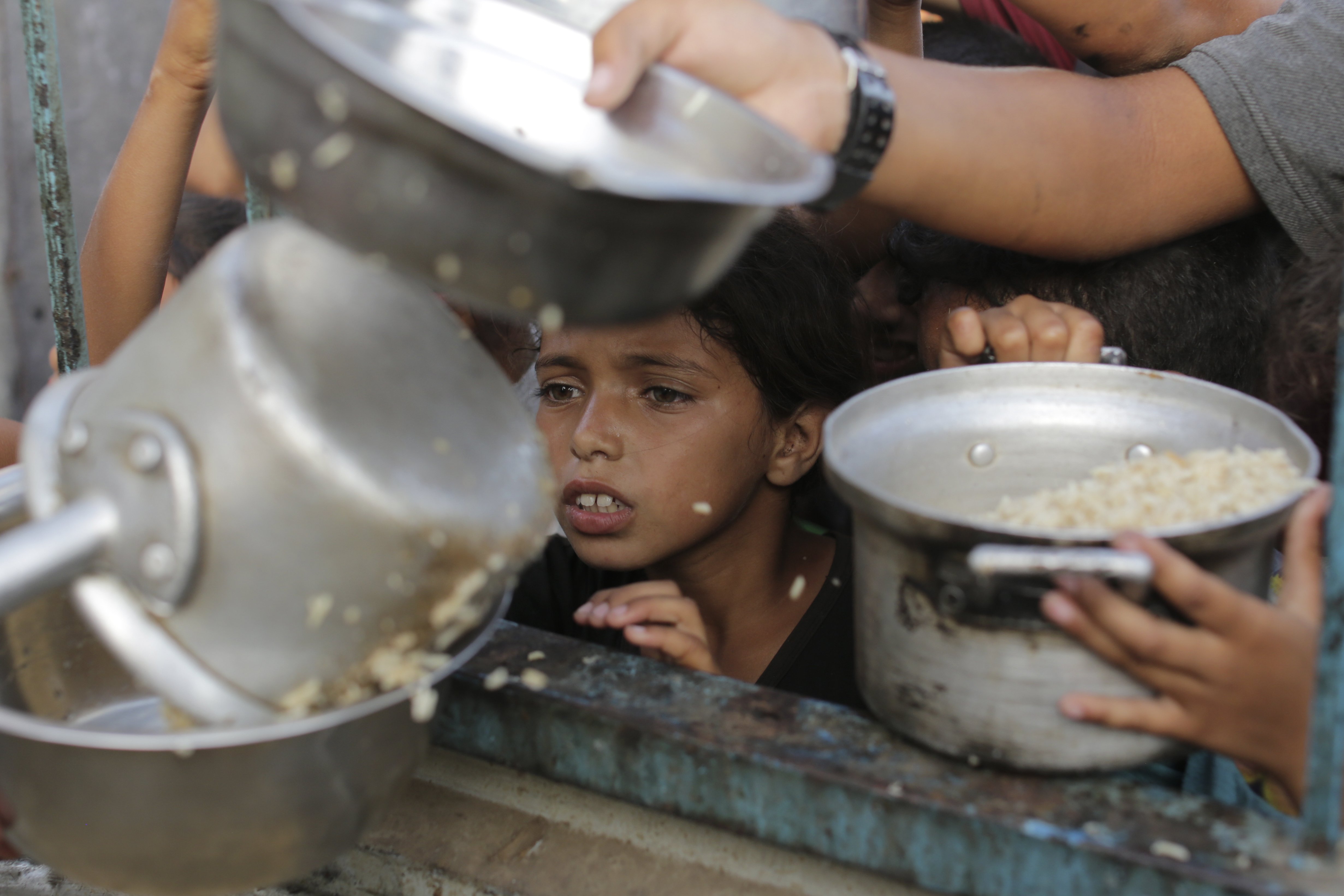 A Palestinian boy watches his portion of food aid closely ahead of the upcoming Eid al-Adha holiday in Jerusalem. Pictured on June 15, 2024. Photo / AP