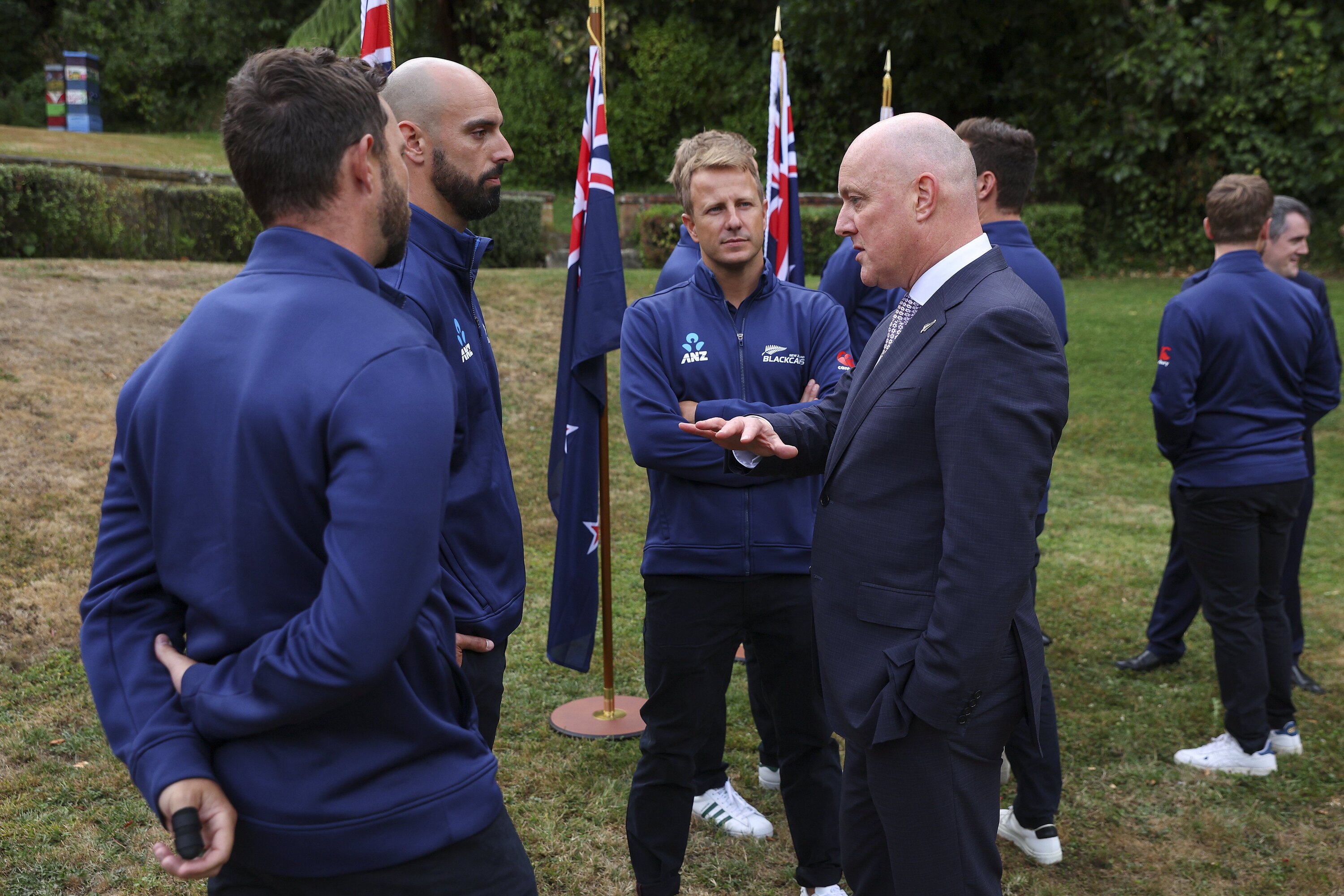 Prime Minister Christopher Luxon talks to, from left, Devon Conway, Daryl Mitchell and Neil Wagner. Photo / Hagen Hopkins