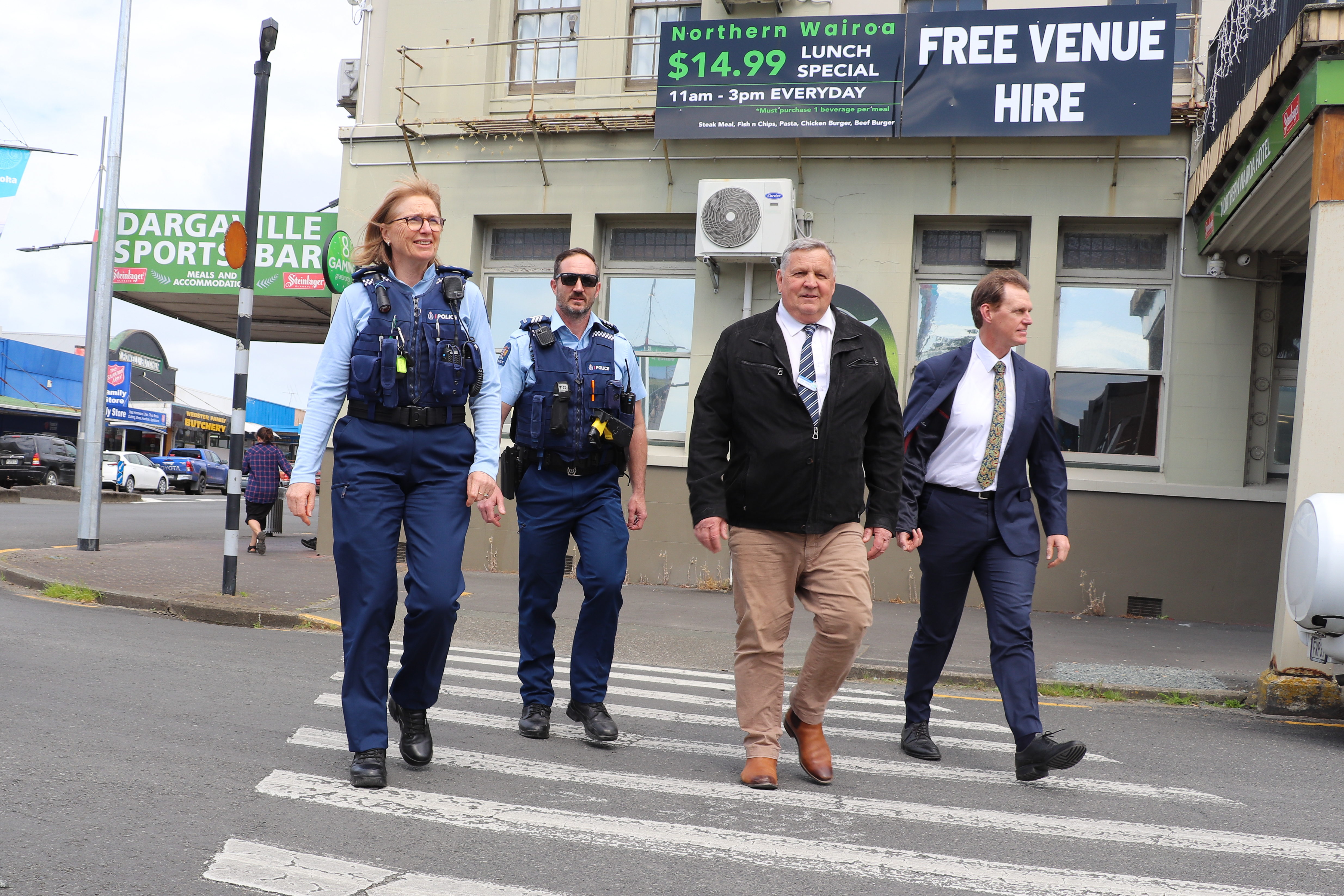 Inspector Maria Nordstrom, Sergeant Kiley Dalbeth and Kaipara Mayor Craig Jepson with deputy mayor Jonathan Larsen during a visit to businesses in Dargaville. Photo / Northland police