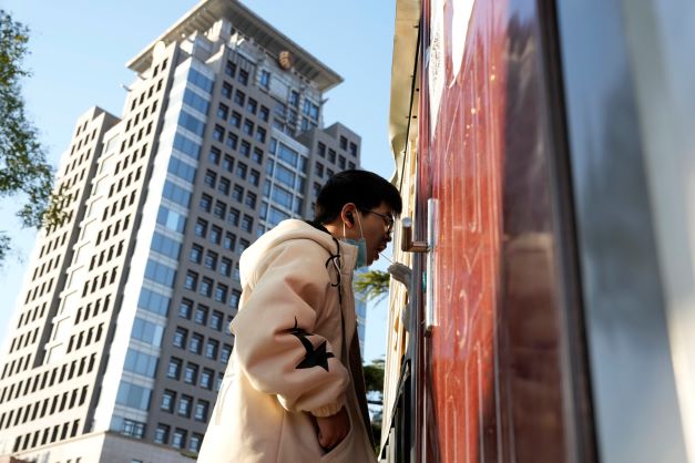 A man gets swabbed for Covid near a building of the Peking University in Beijing on Wednesday. Chinese authorities locked down the major university after finding one Covid-19 case as they stick to a 