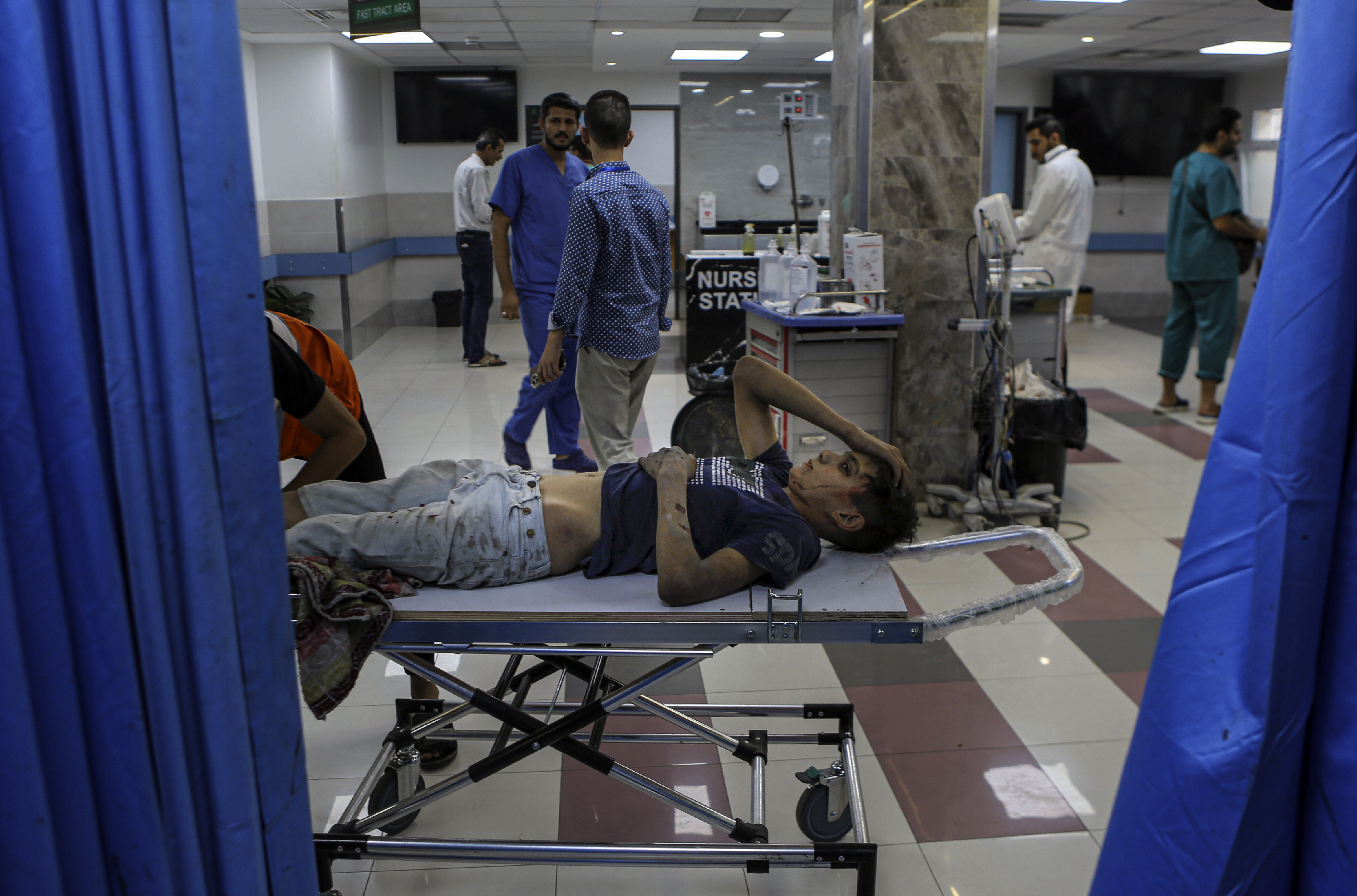 A wounded Palestinian boy arrives in the emergency room of the al-Shifa hospital, following Israeli airstrikes on Gaza City. Photo / AP
