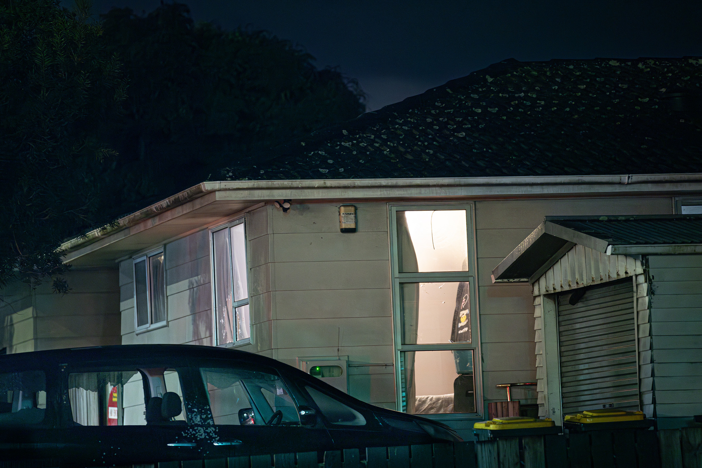 Police continue to guard the scene following a drive-by shooting in Weymouth overnight. Photo / Hayden Woodward