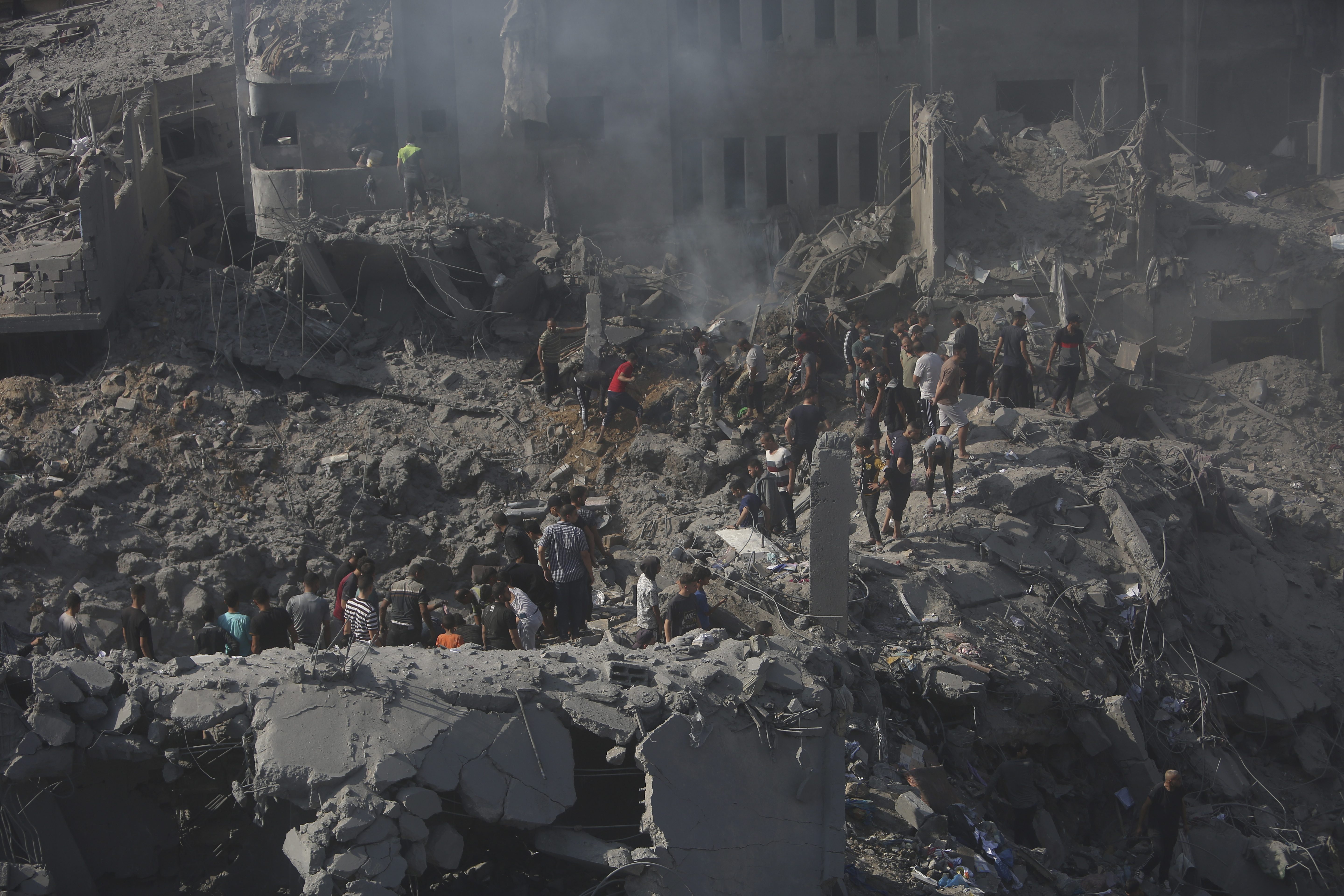 Palestinians look for survivors in the rubble of a destroyed building following an Israeli airstrike in Bureij refugee camp, Gaza Strip. Photo / AP