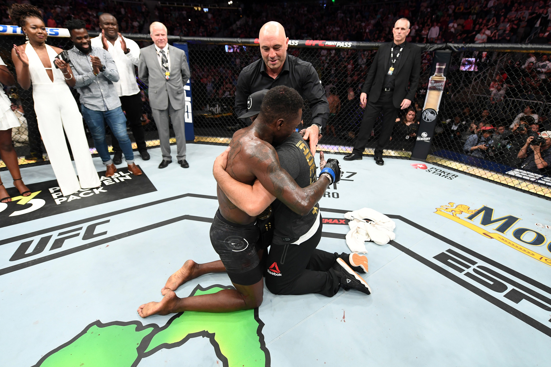 Israel Adesanya hugs coach Eugene Bareman after winning the UFC interim middleweight championship. Photo / Getty Images