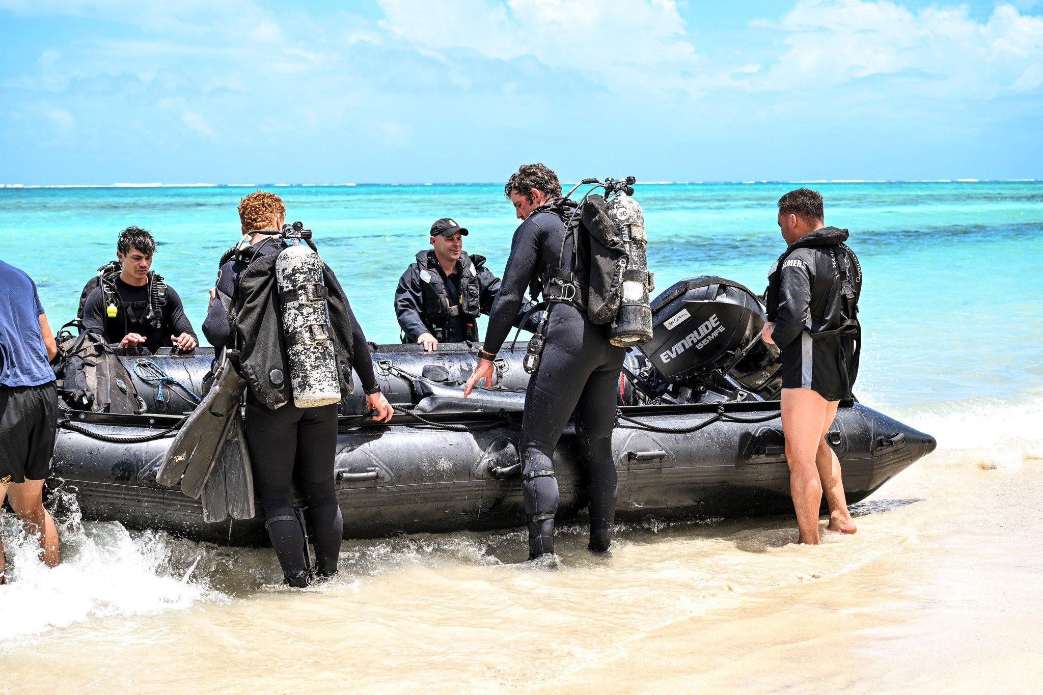 Navy divers prepare to set out and recover items from the HMNZS Manawanui after it sank. Photo / Supplied