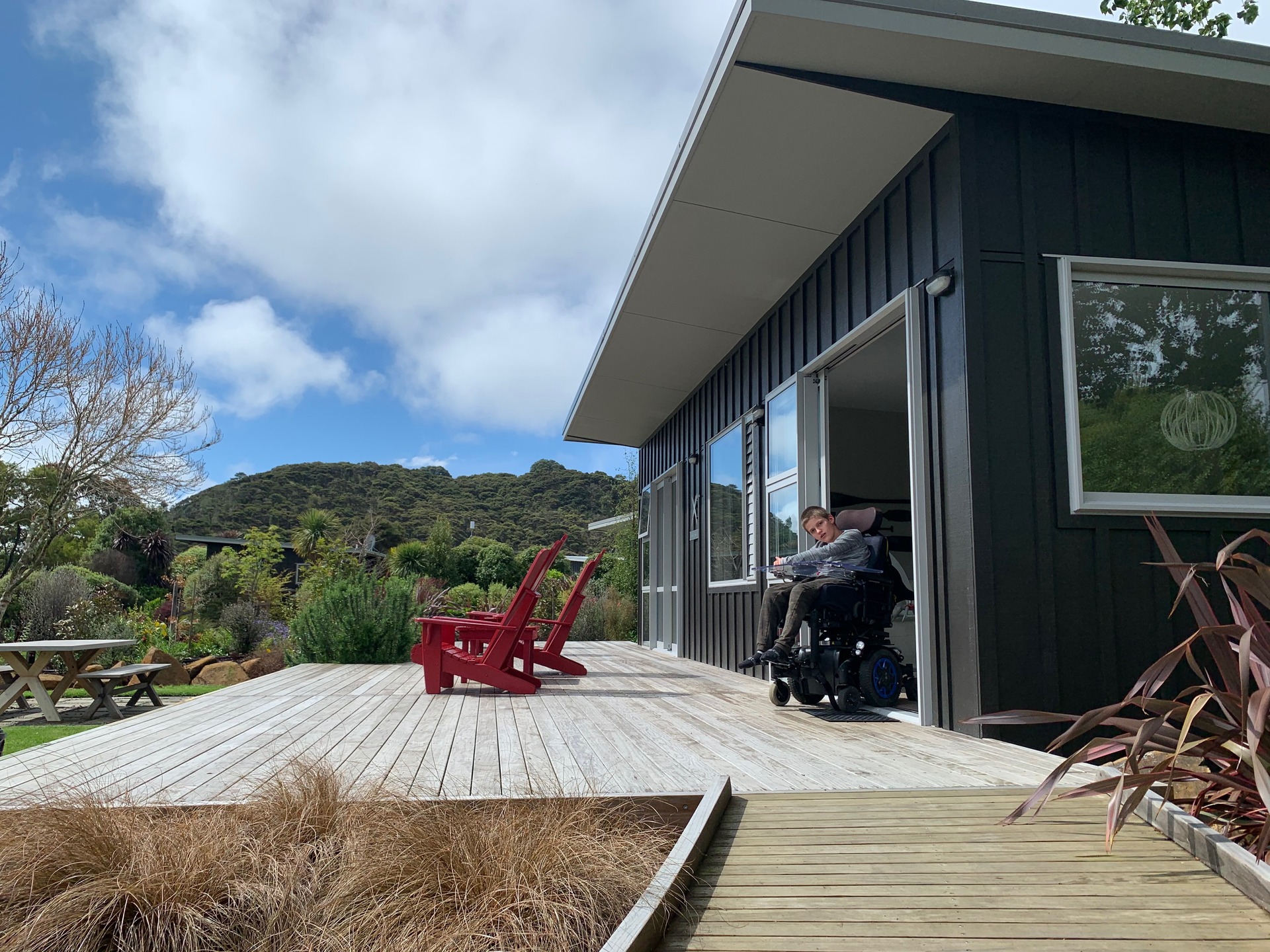 Finlay Graham at the accessible chalet in Flaxmill Bay, Coromandel. Photo / Kimberly Graham