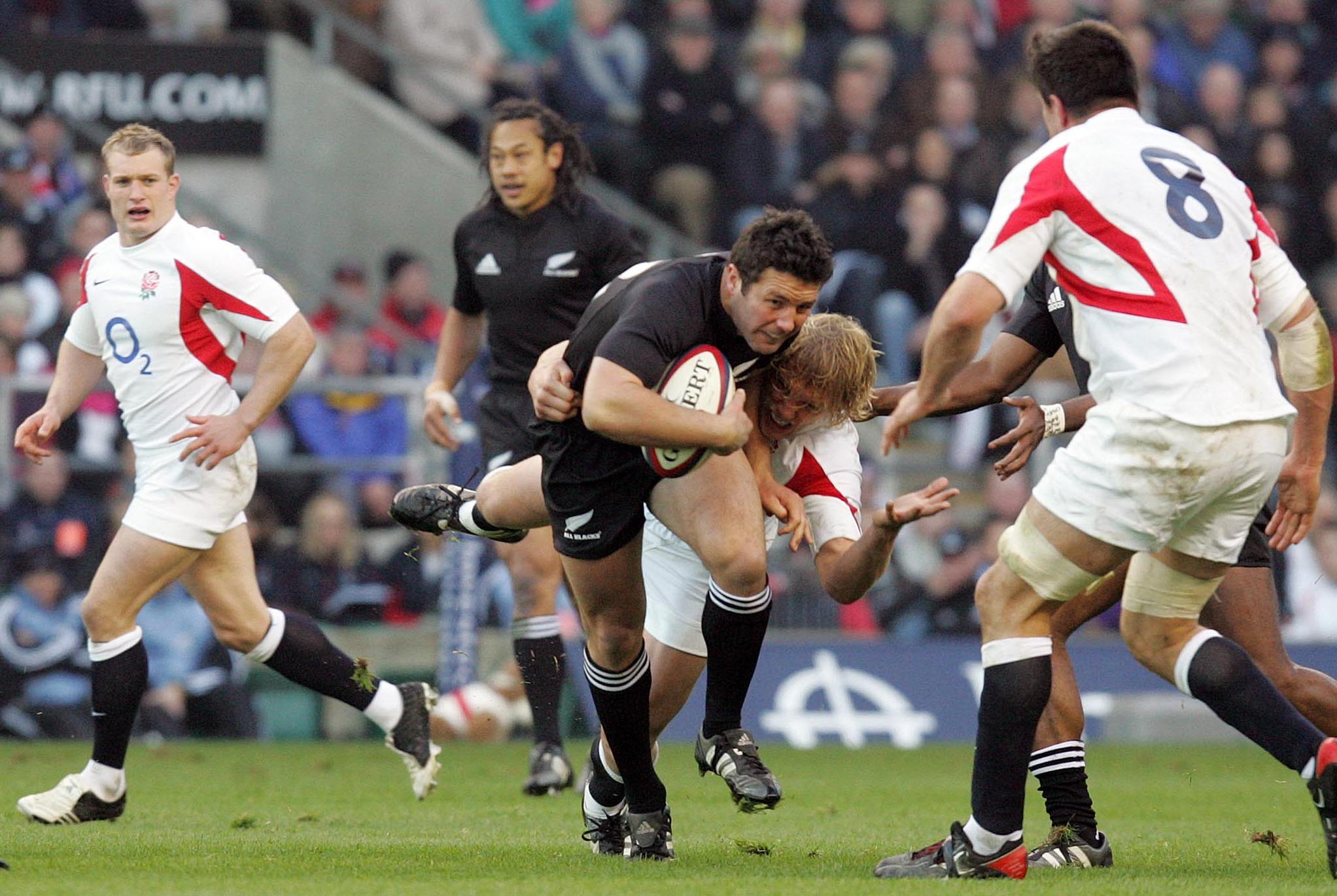 Aaron Mauger is tackled during the All Blacks' 23-19 win over England. Photo / Photosport