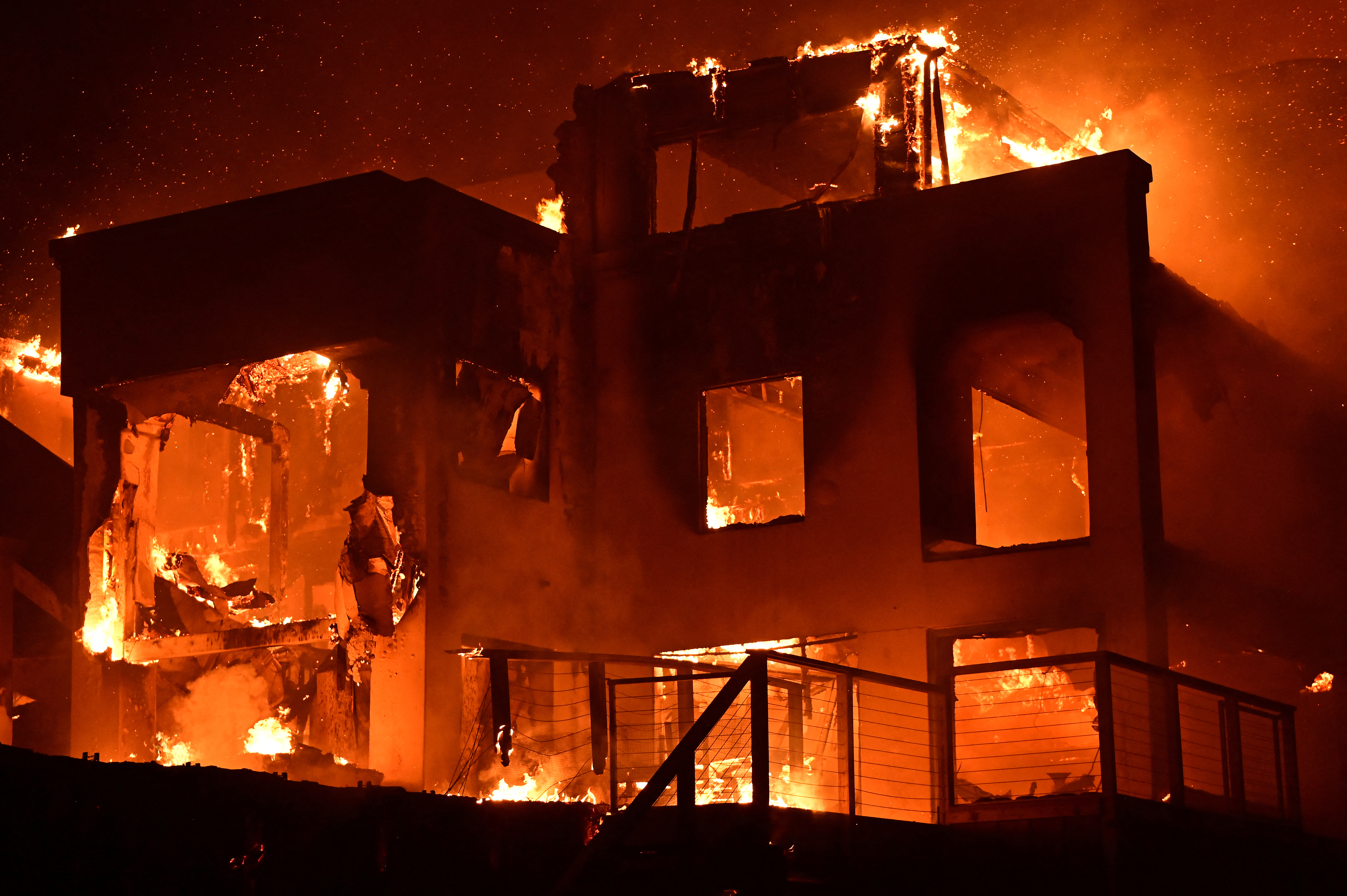 A house is engulfed in flames as the Palisades fire burns along the Pacific Coast Highway in Malibu, Los Angeles. Photo / AFP