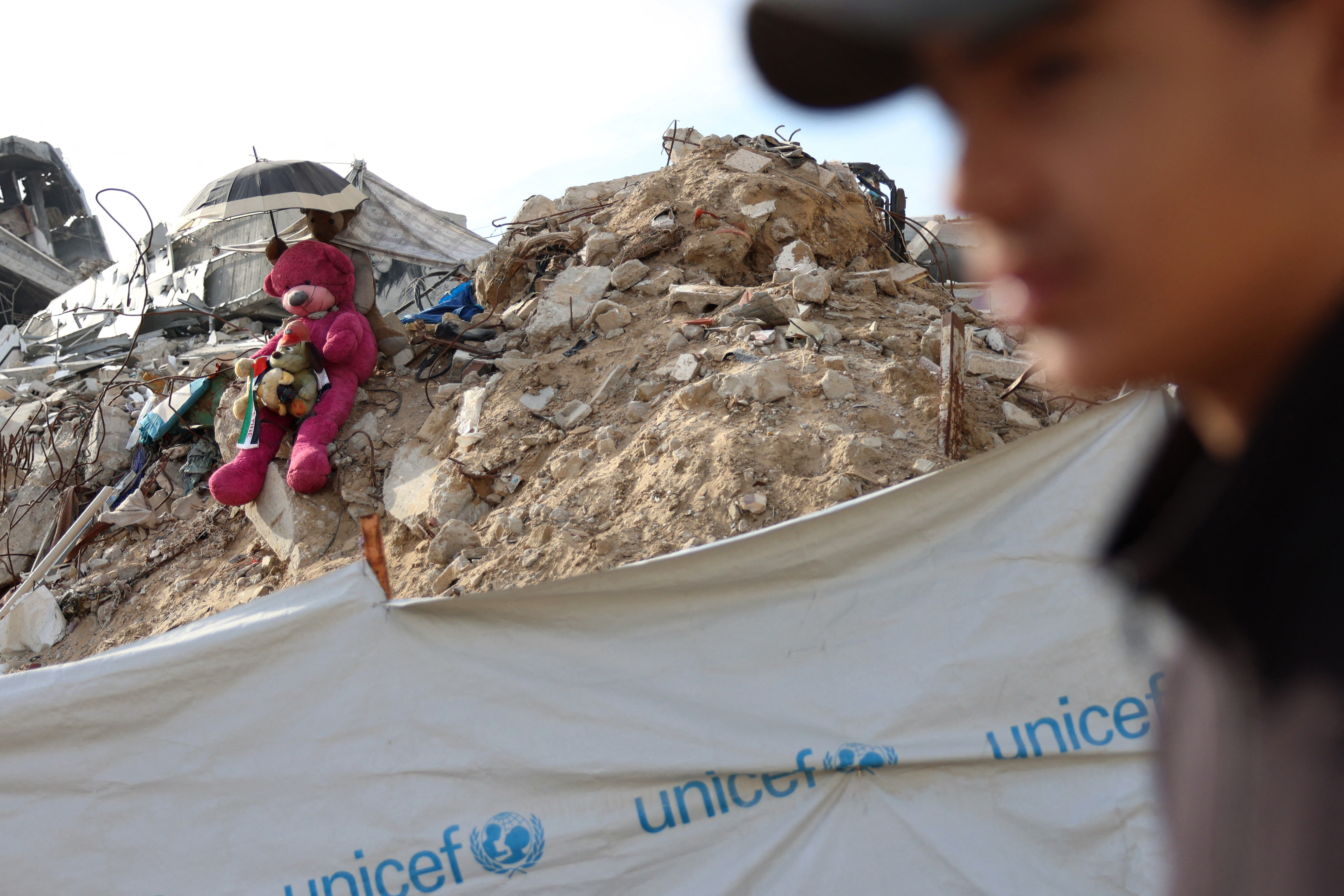 A Palestinian youth walks past an installation composed of stuffed animals set up on a pile of debris, in Khan Yunis in the south Gaza Strip on December 10. Photo / AFP