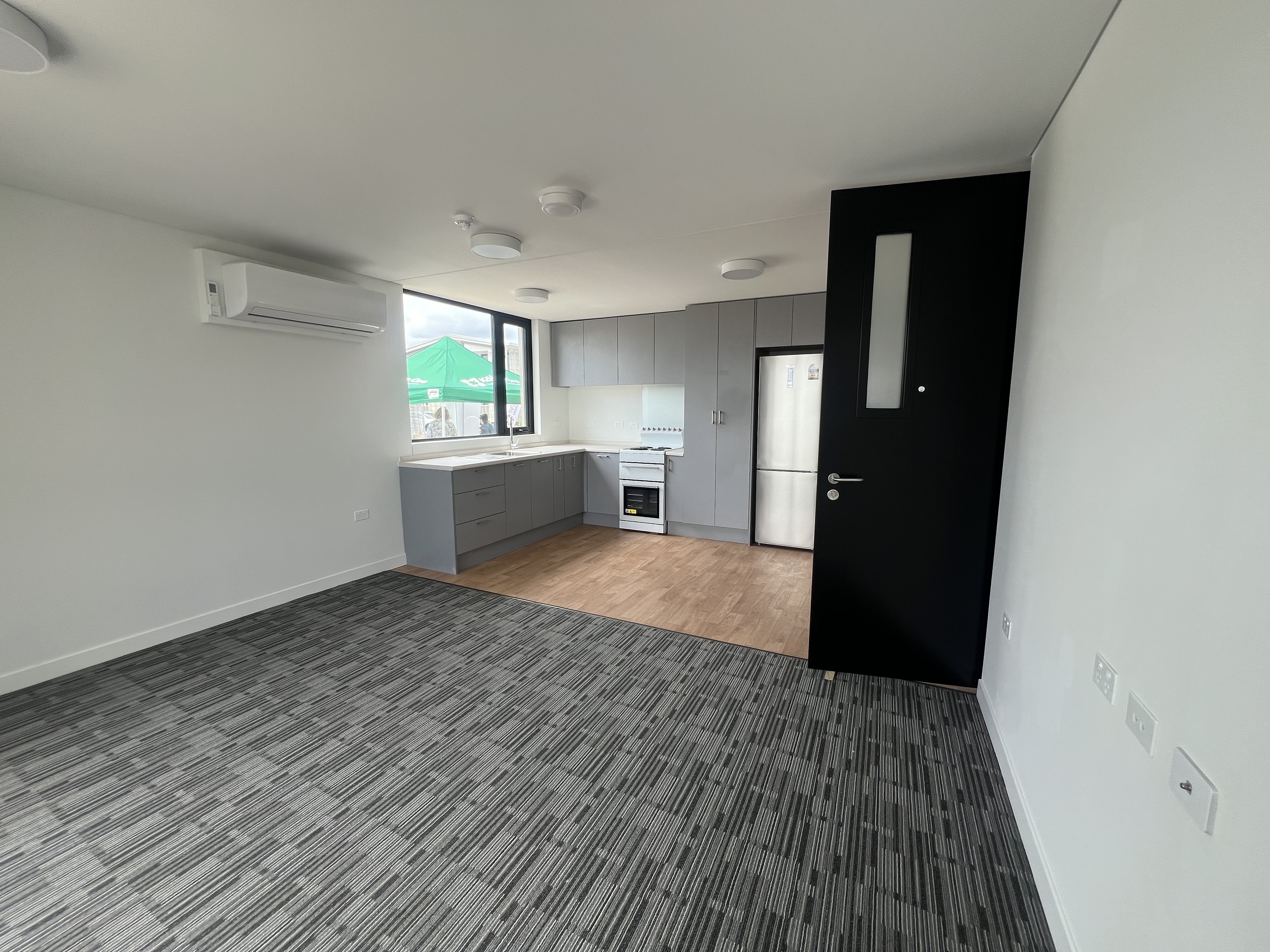 The kitchen and lounge area of one of the 12 new Kāinga Ora apartments on the corner of Ranolf St and Malfroy Rd. Photo / Kelly Makiha