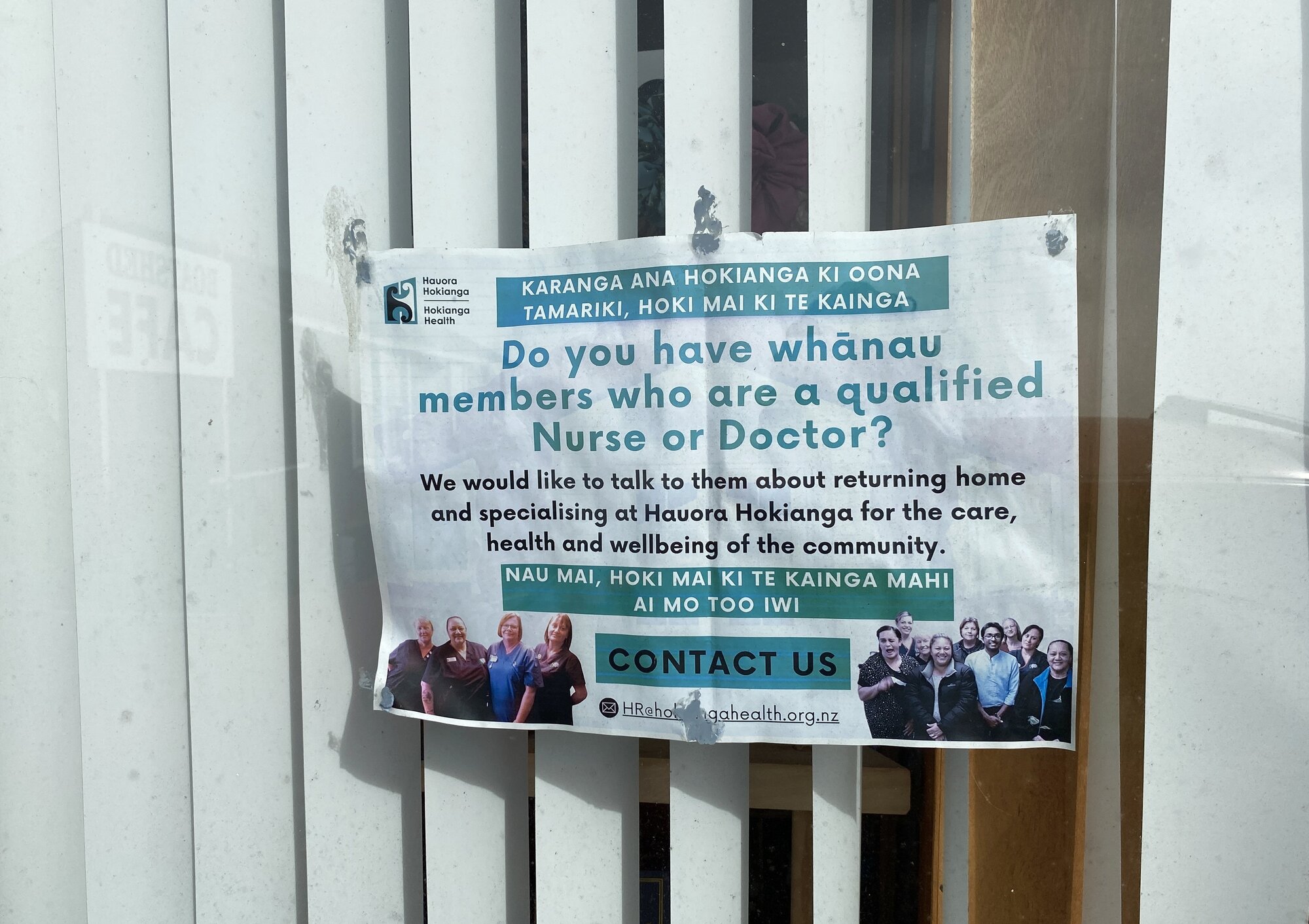 A faded sign in Rawene pleads for clinical staff to return home and work for Hauora Hokianga. Photo / Denise Piper