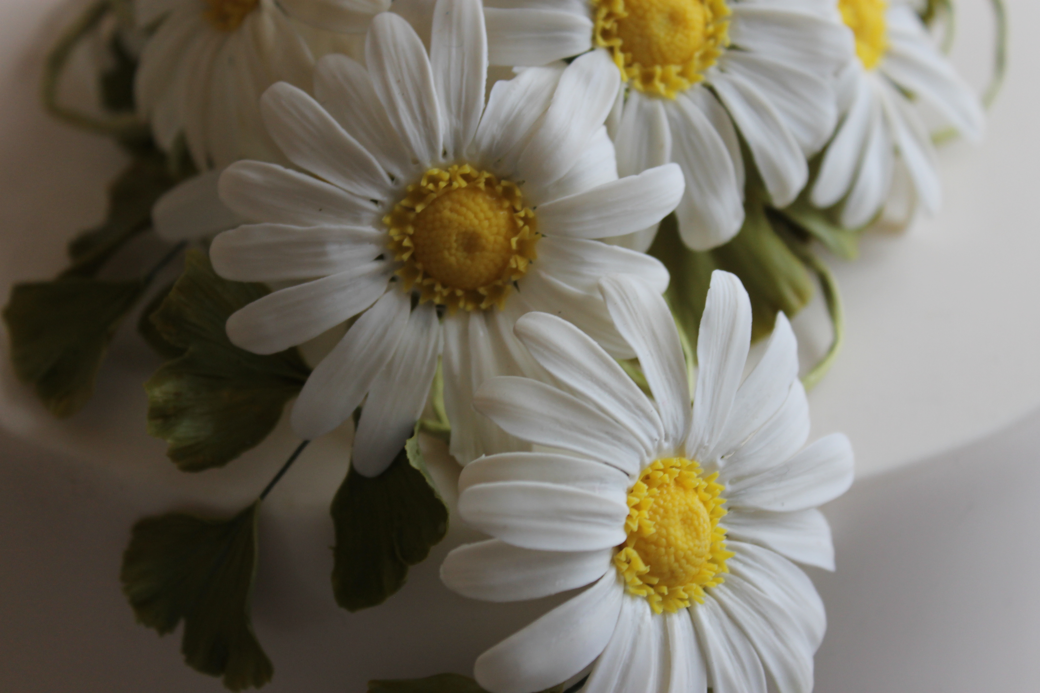 Wedding cake marguerite daisies and ginkgo leaves made by Mary Parker before she died. Photo / Kim Knight