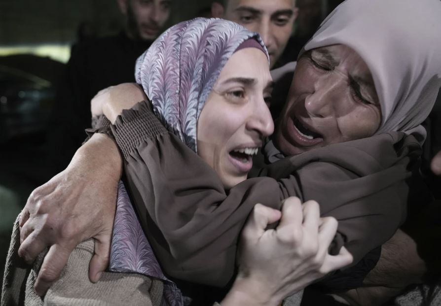 Shuruq Dwayat, left, a Palestinian prisoner released by Israel, is hugged by relatives as she arrives home in the east Jerusalem neighborhood of Sur Bahar. Photo / AP