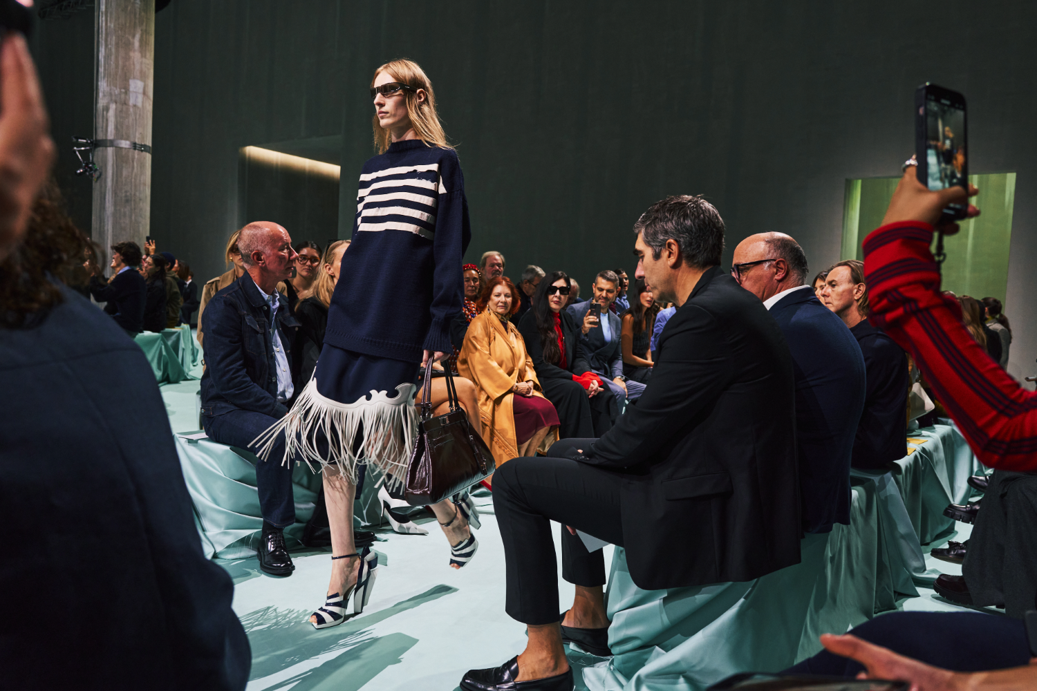 A navy-and-white-striped sweater looked less nautical paired with a fringed skirt on the runway at Prada. Photo / Simbarashe Cha for The New York Times