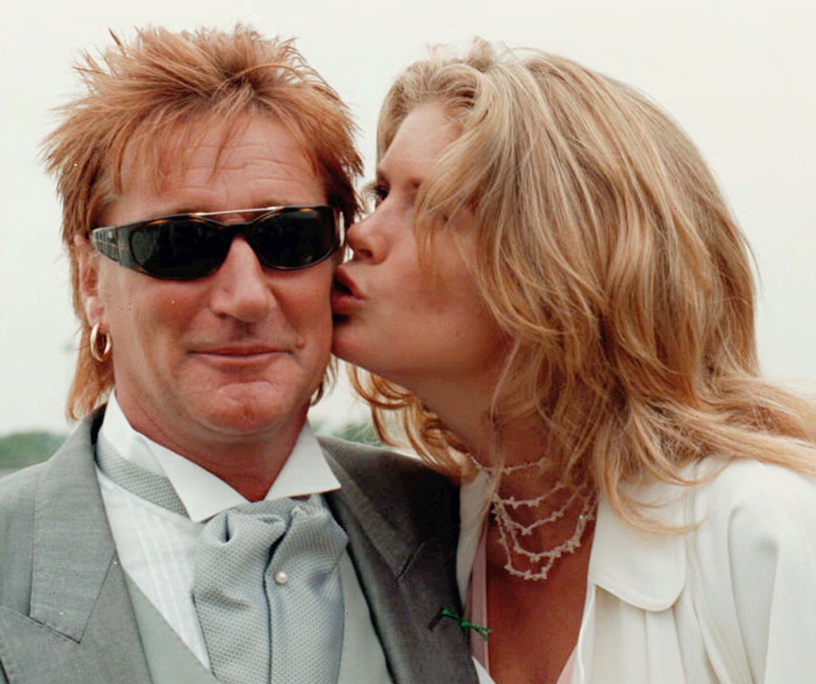 Rachel Hunter gives her then-husband Rod Stewart a kiss from his wife. Photo / AP