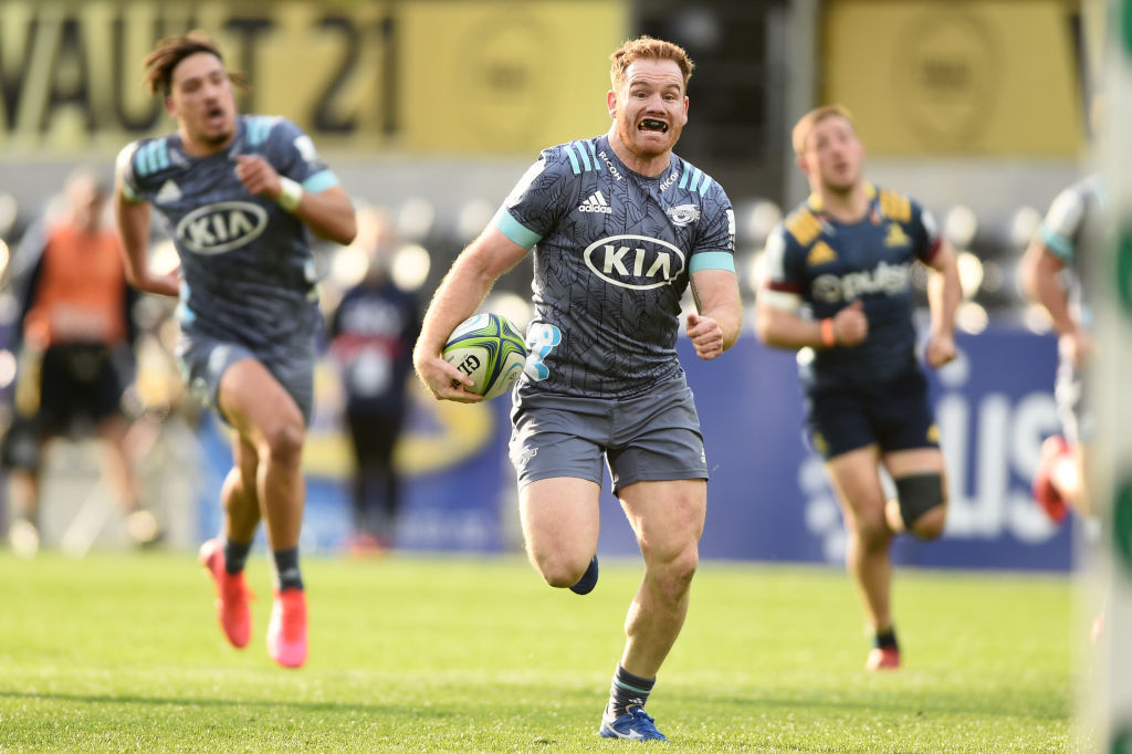 Jamie Booth of the Hurricanes runs in to score a try against the Highlanders. Photo / Getty