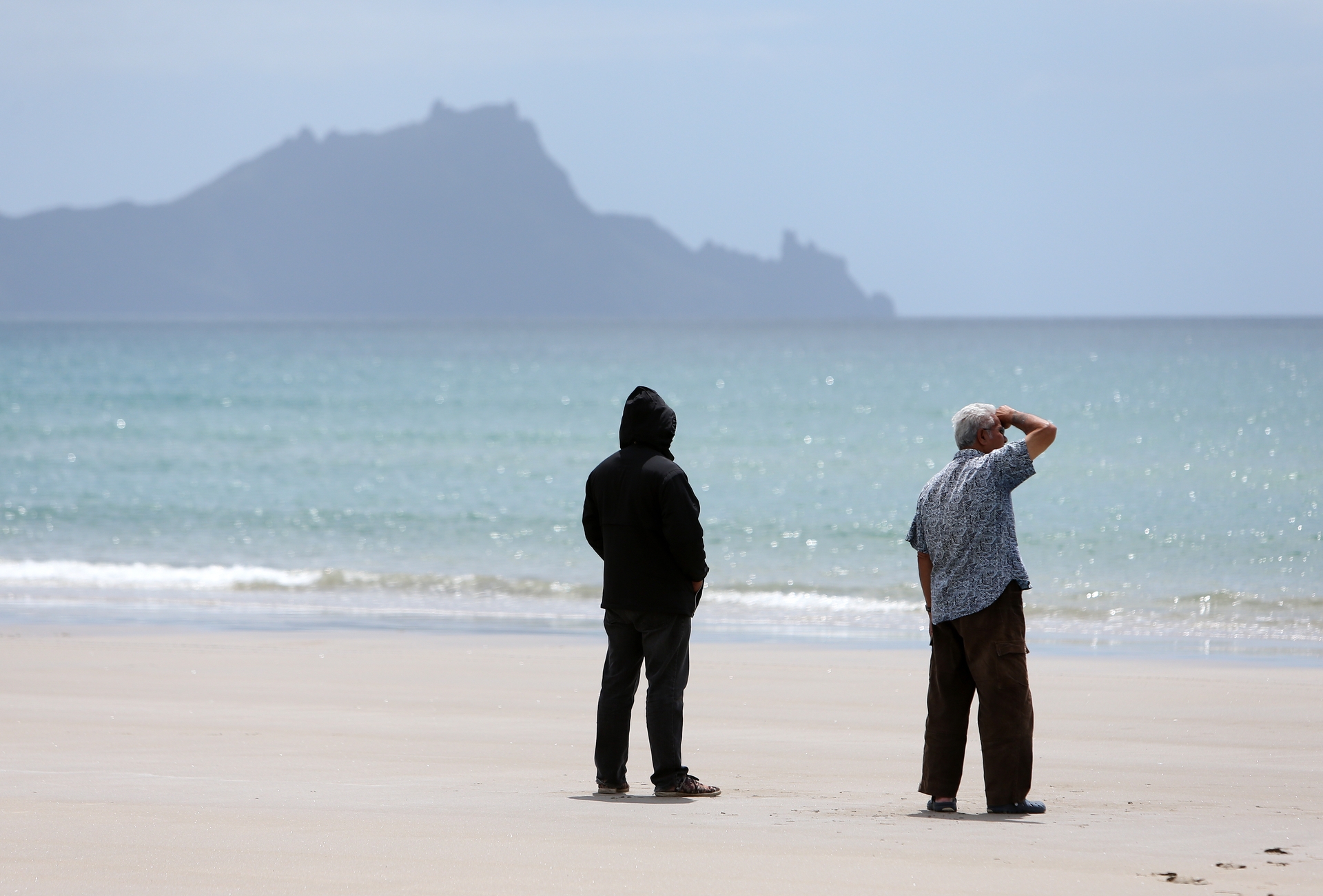 Friends and family of the missing man gathered at Uretiti Beach yesterday. Photo / Michael Cunningham