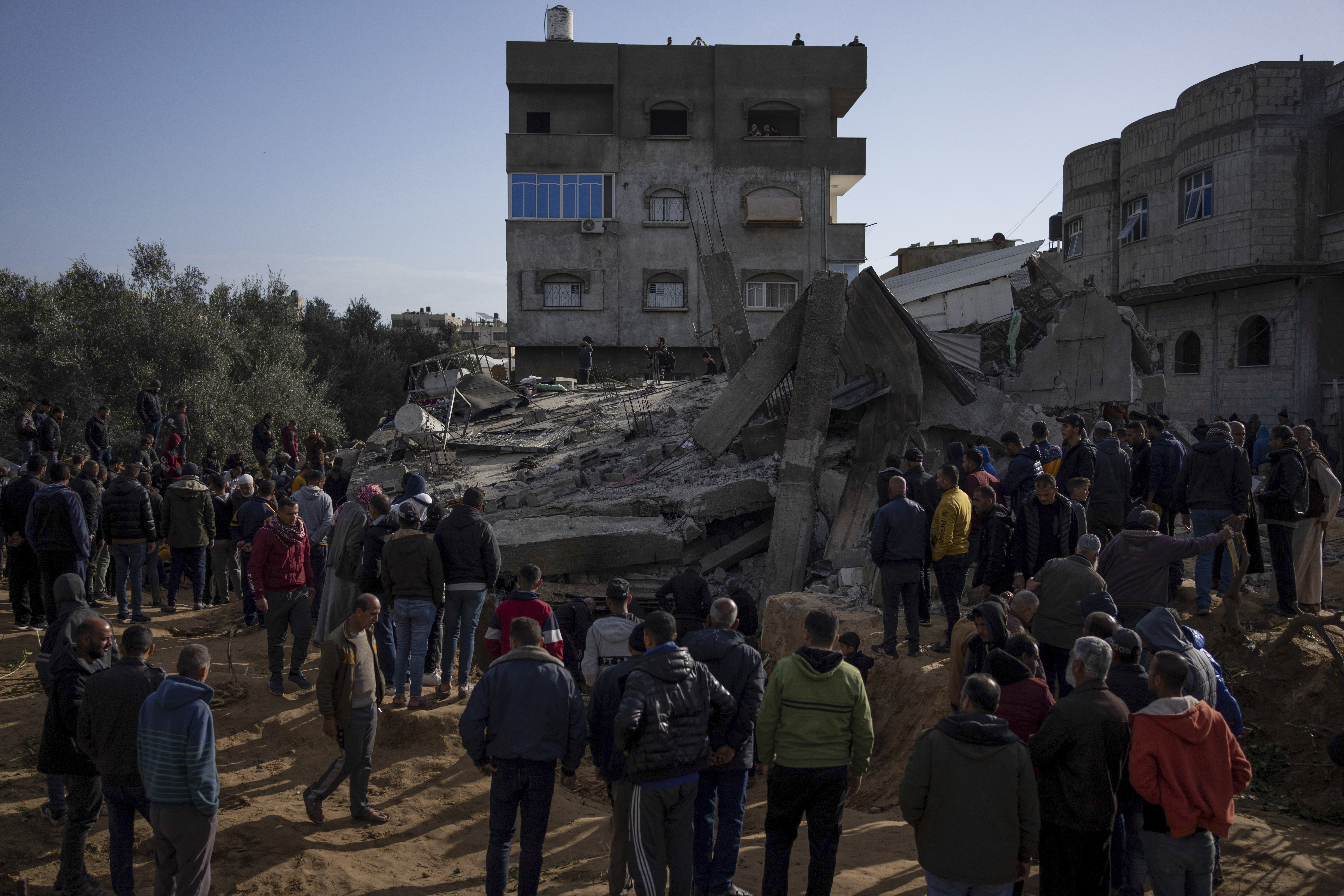 Palestinians search for bodies and survivors amid the rubble of a residential building destroyed by an Israeli airstrike in Rafah, Gaza Strip. Photo / AP