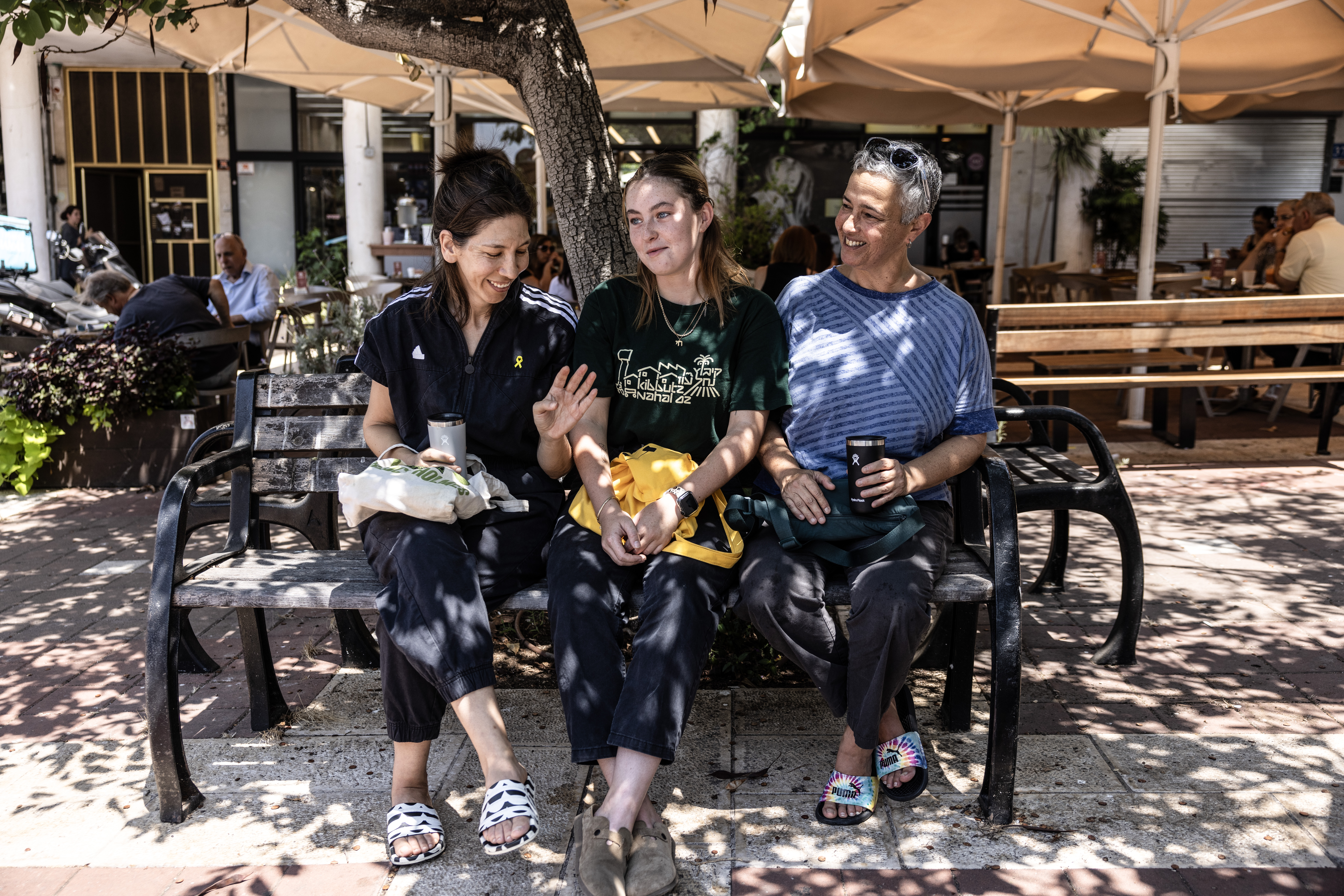 Nurit Livnet Levanson, 47, left, and Galit Livnet Levanson, 55, with their daughter Mika Livnet Levanson, 19, a commander in the Israeli Air Force, sit outside a cafe in Haifa on Sunday. Photo / Heidi Levine for The Washington Post