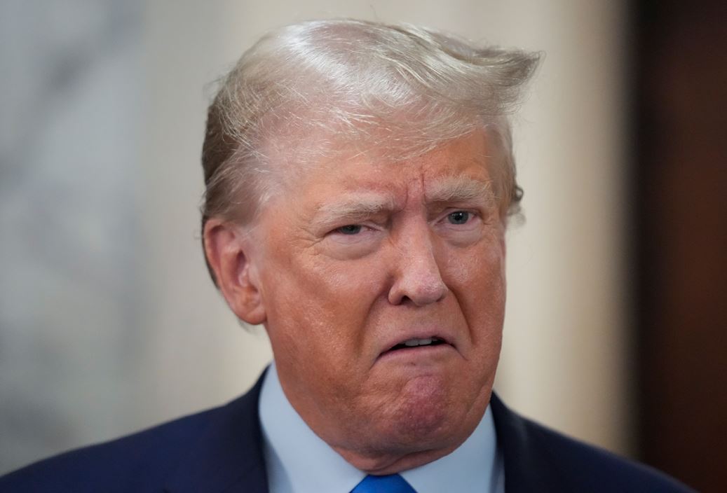 Former President Donald Trump speaks to reporters during a lunch break. Photo / AP