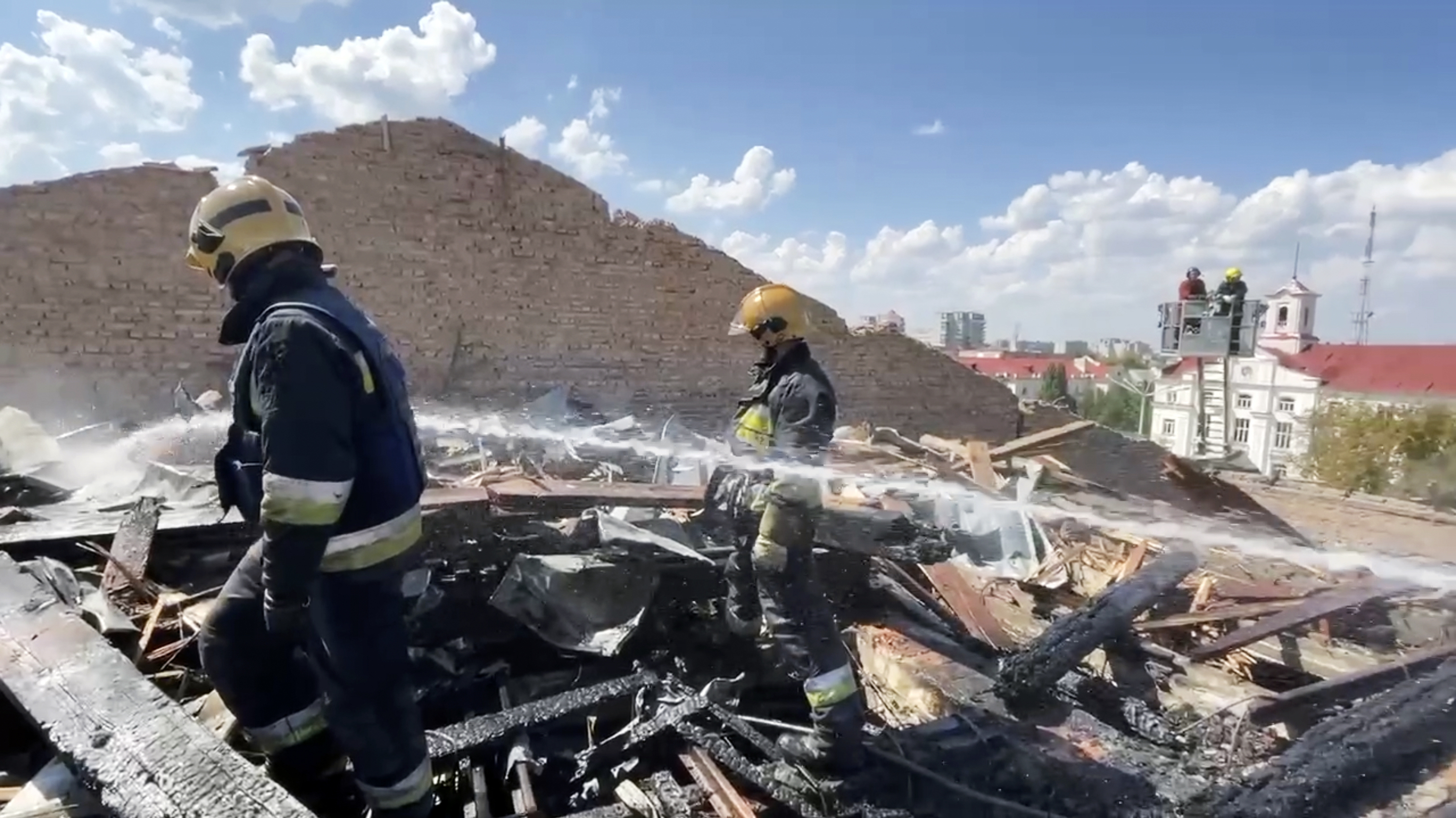 In this photo taken from video provided by the Ukrainian Emergency Service, firefighters work on the roof of the Taras Shevchenko Chernihiv Regional Academic Music and Drama Theatre damaged by Russian attack in Chernihiv, Ukraine. Photo / AP