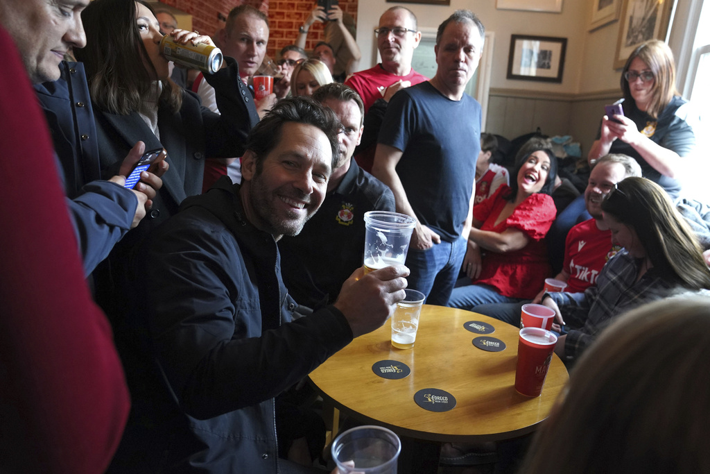 US actor Paul Rudd sits alongside Wrexham fans in The Turf Pub ahead of the National League football match between Wrexham and Boreham Wood at The Racecourse Ground. Photo / AP