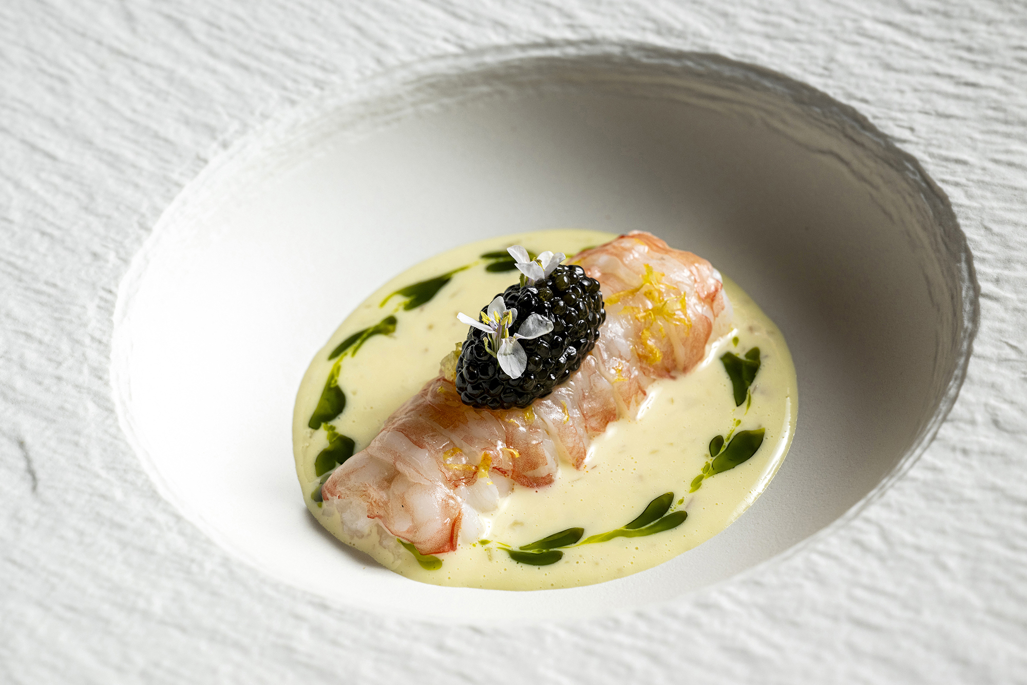 The langoustine at Jungsik is garnished with caviar and surrounded by an emulsion of dongchimi, a radish kimchi in brine, in New York. Photo / Evan Sung, The New York Times