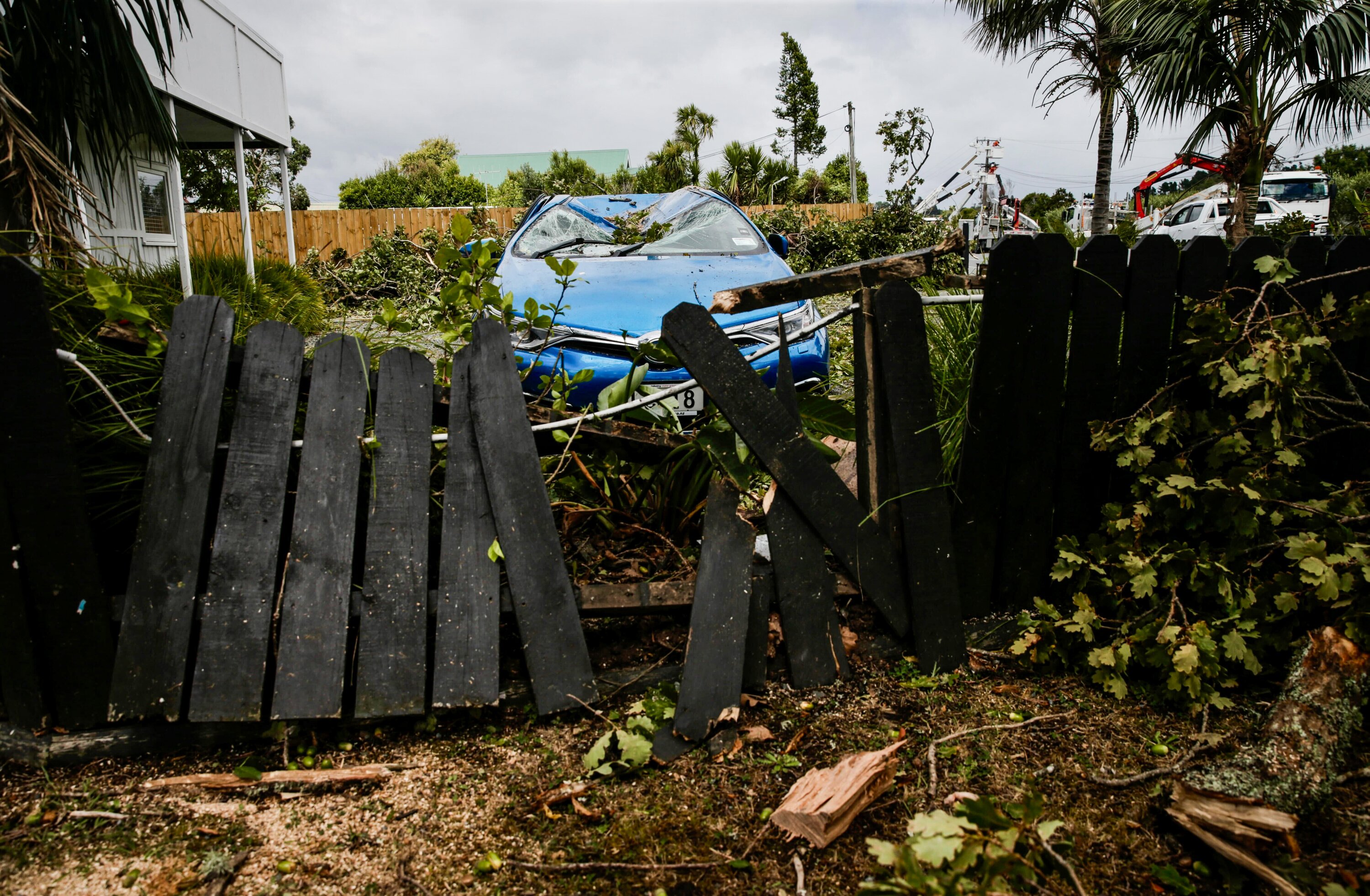 This fence and vehicle were among scores of cases of damage caused by a tornado that ripped through Mangawhai yesterday. Photo / Alex Burton
