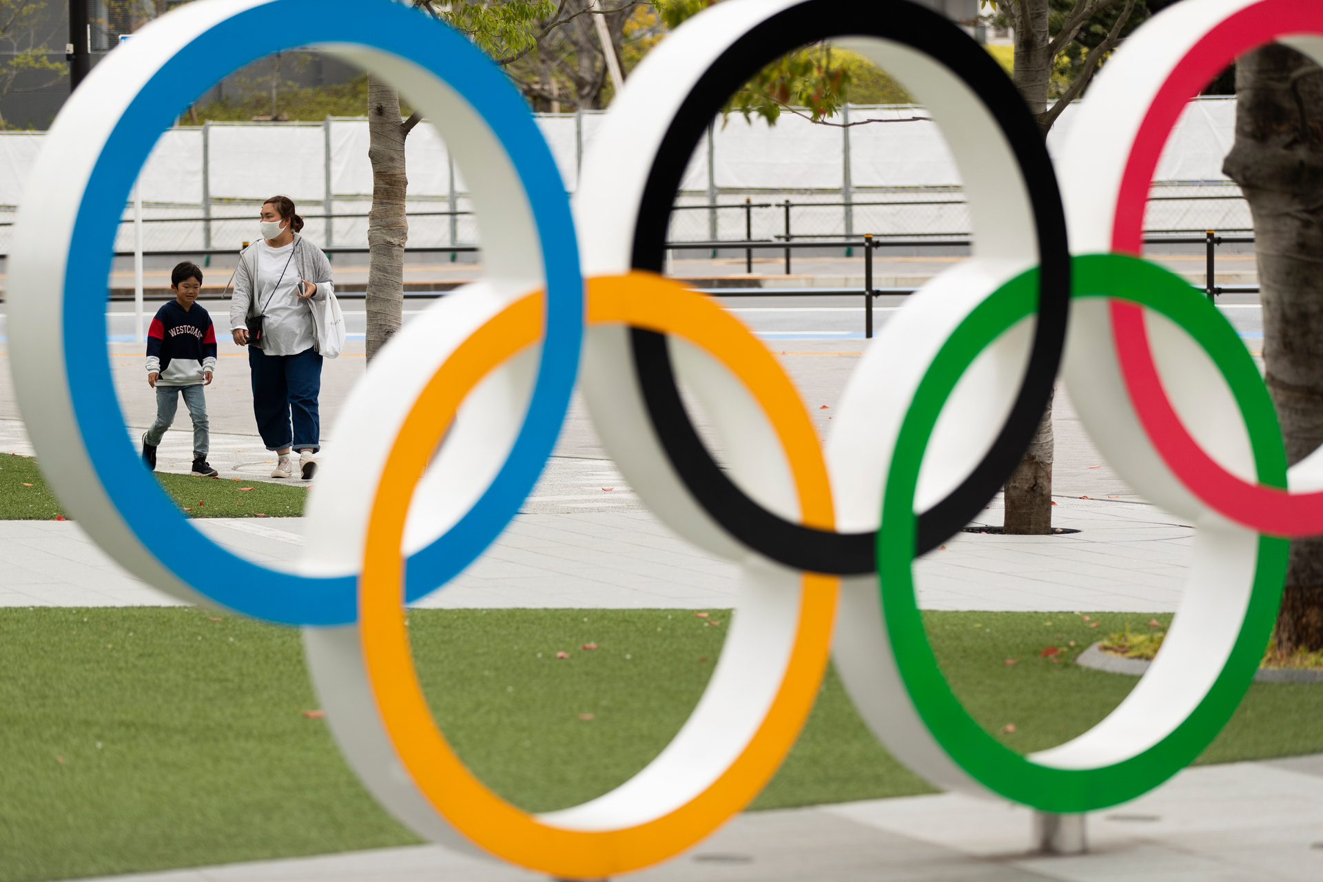 A mother and a boy walk by a display of the Olympic rings at the Japan Olympic Museum in Tokyo. Photo / AP
