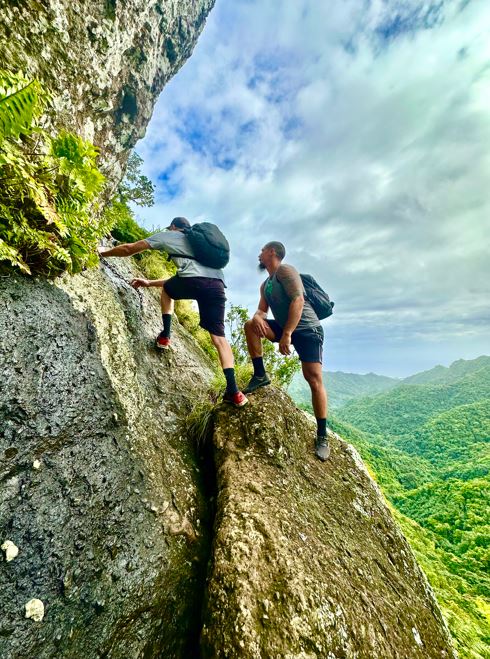 Scrambling up tree-root jungle staircases with Maunga Tours in Rarotonga. Photo / Tim Roxborogh