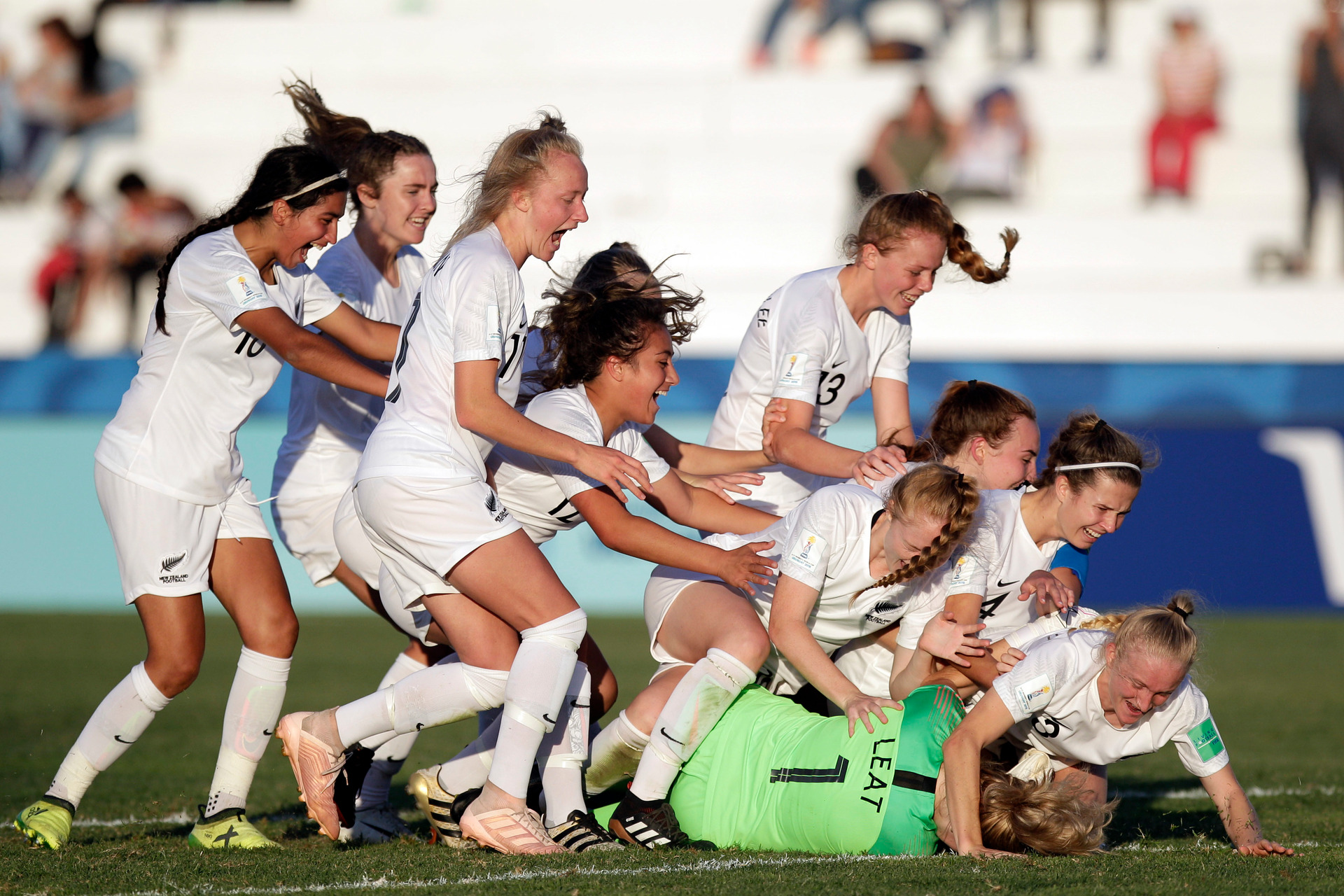 New Zealand players embrace goalkeeper Anna Leat after she scored the final penalty during a penalty shootout in the team's quarter-final match against Japan. Photo / AP 