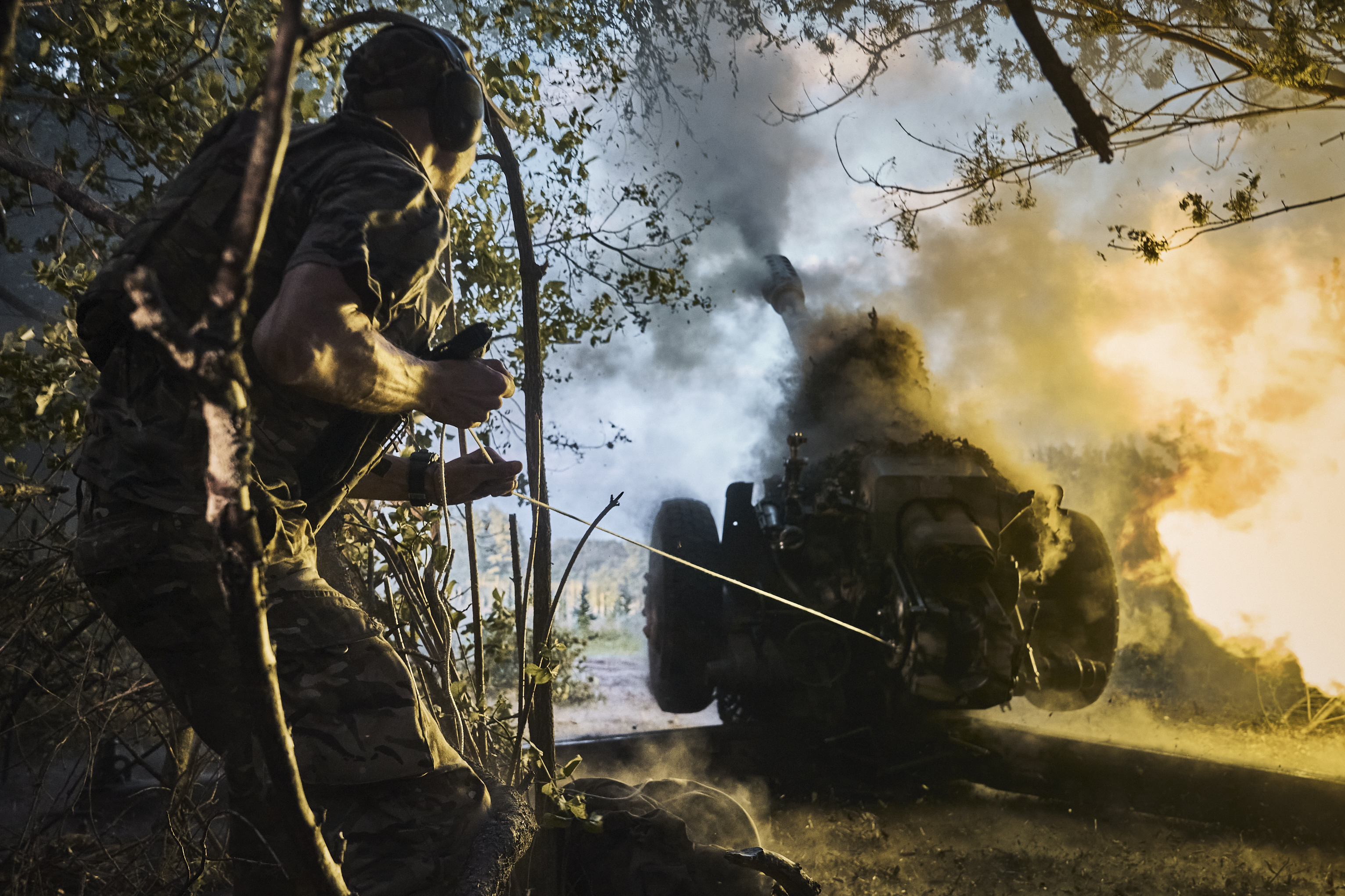 Russia's invasion began on 24 February 2022. A photo from 7 July shows a Ukrainian policeman firing a cannon towards Russian positions at the front line, near Kreminna in the Luhansk region. Photo / AP / Libkos
