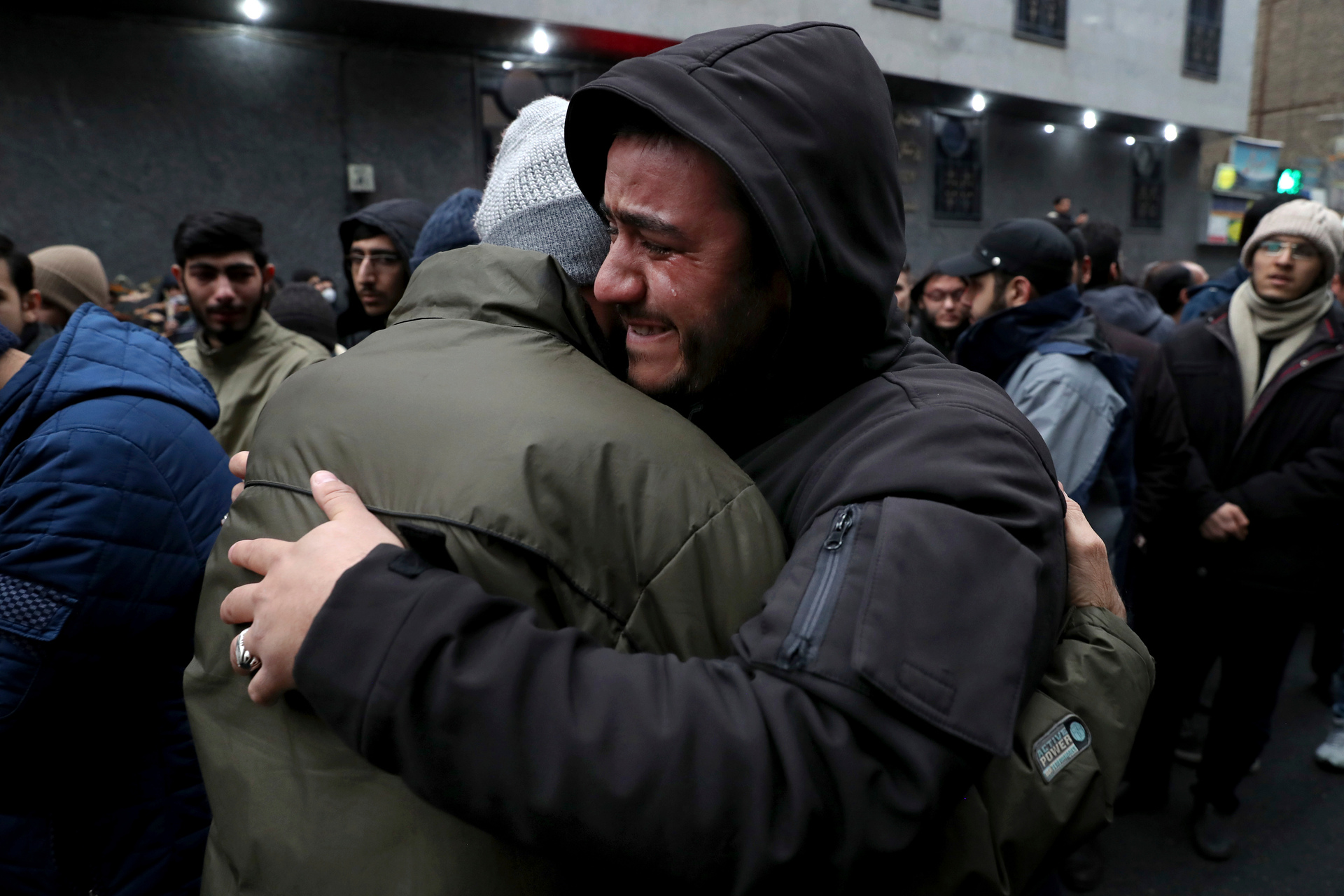 Two Iranian weep while mourning during a demonstration over the US airstrike in Iraq. Photo / AP