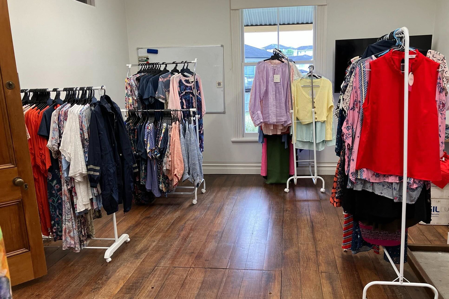 Designer clothes hang from the racks at a Fashion Sister pop-up.