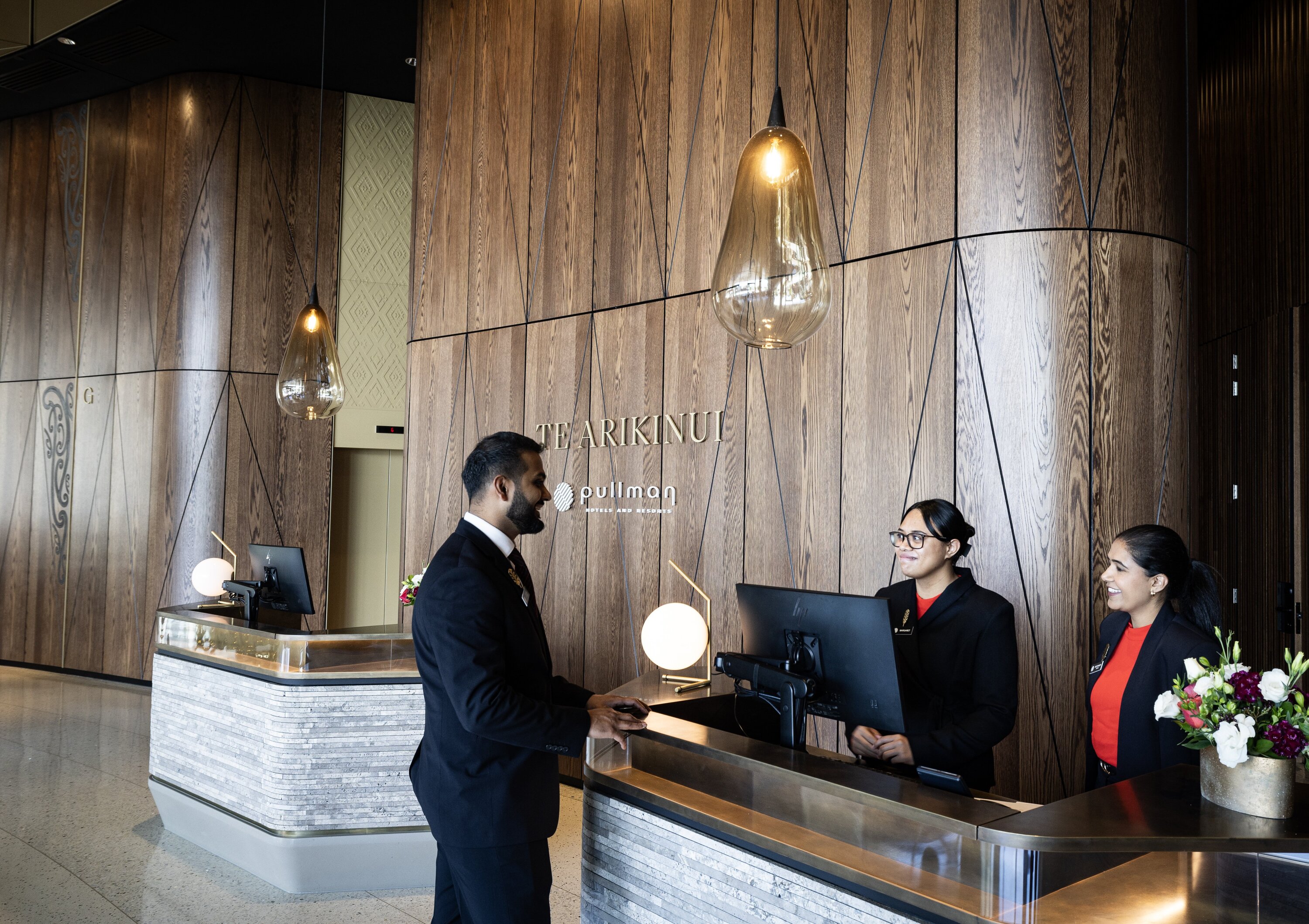 Reception staff at Te Arikinui Pullman Hotel. Photo / Jason Oxenham.
