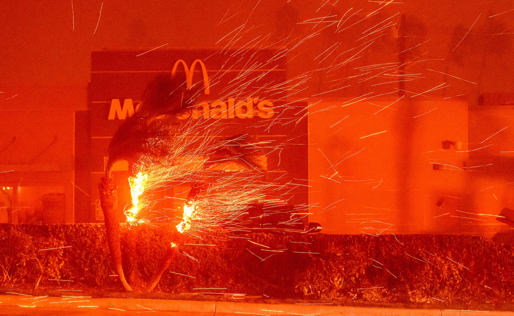 A McDonald's restaurant is showered in embers during the Eaton fire in Pasadena, California. Photo / AFP