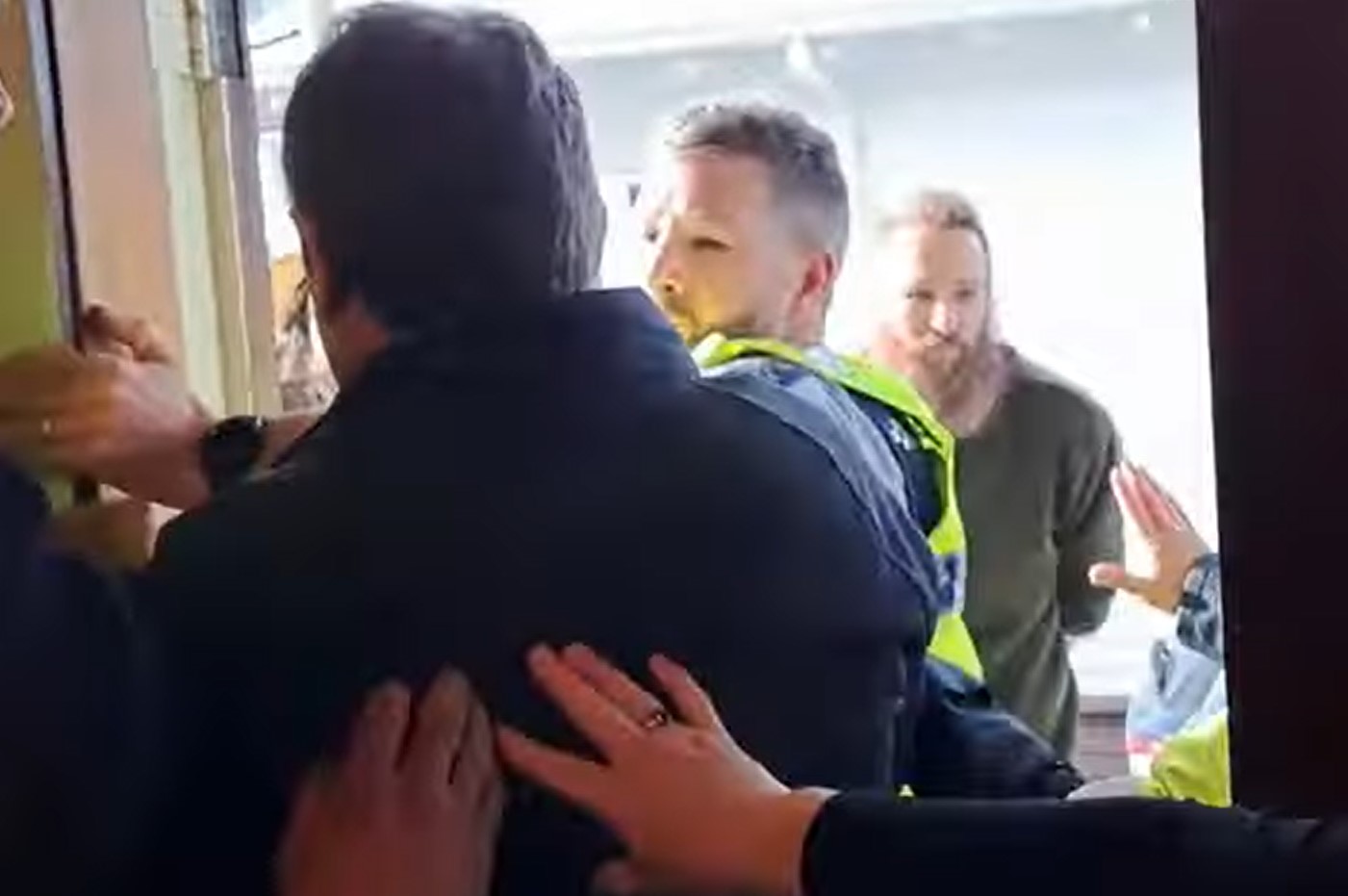In a video, police are forced to break up a large scuffle between Stop Co-Governance protesters and Lee Williams in the doorway of the venue holding the event. July 15, 2023.
