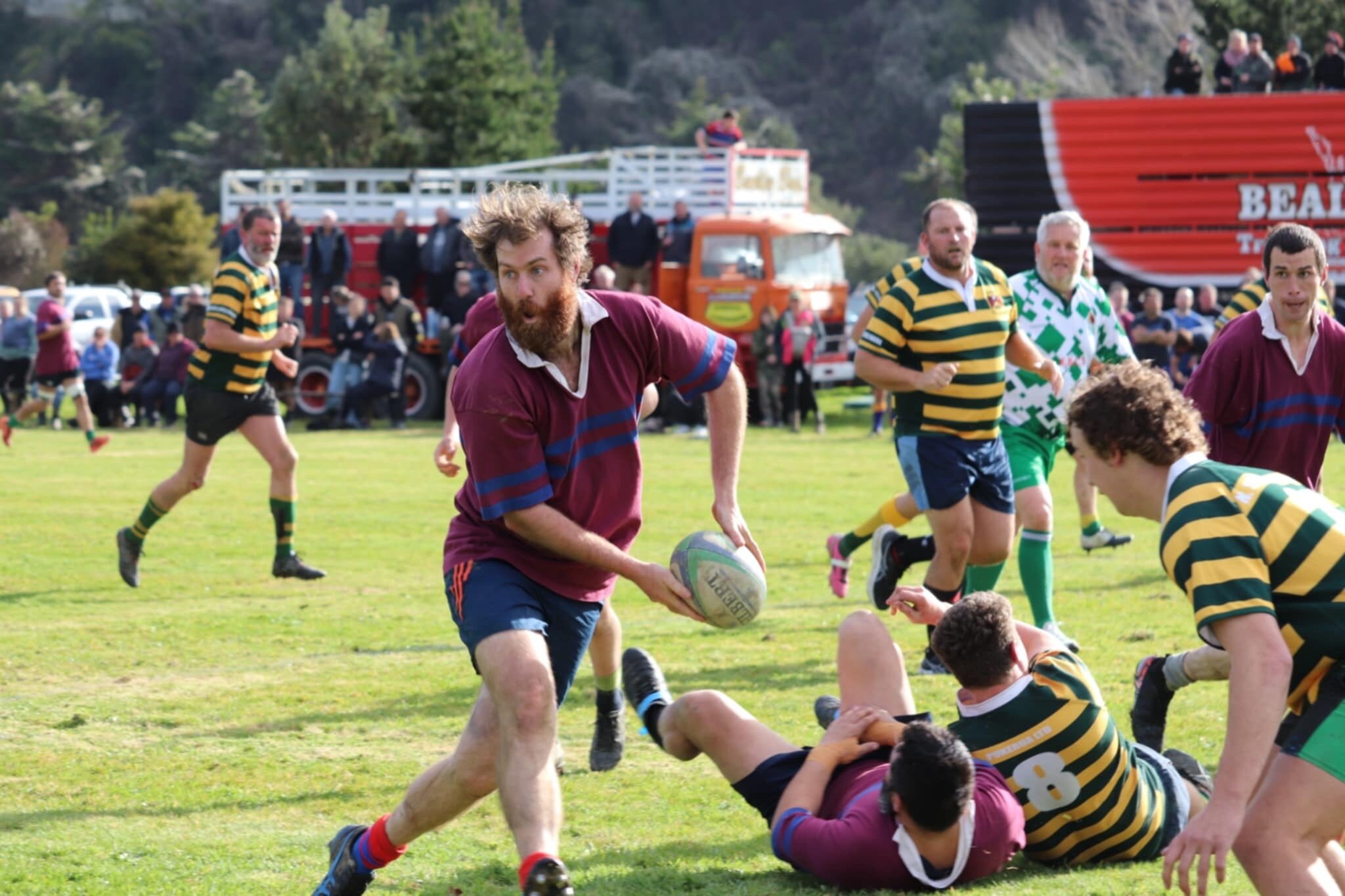  A Mangatainoka player passes the ball before he can be tackled at the game between Mangatainoka OB and Puketoi OB at Mangatainoka rugby grounds.