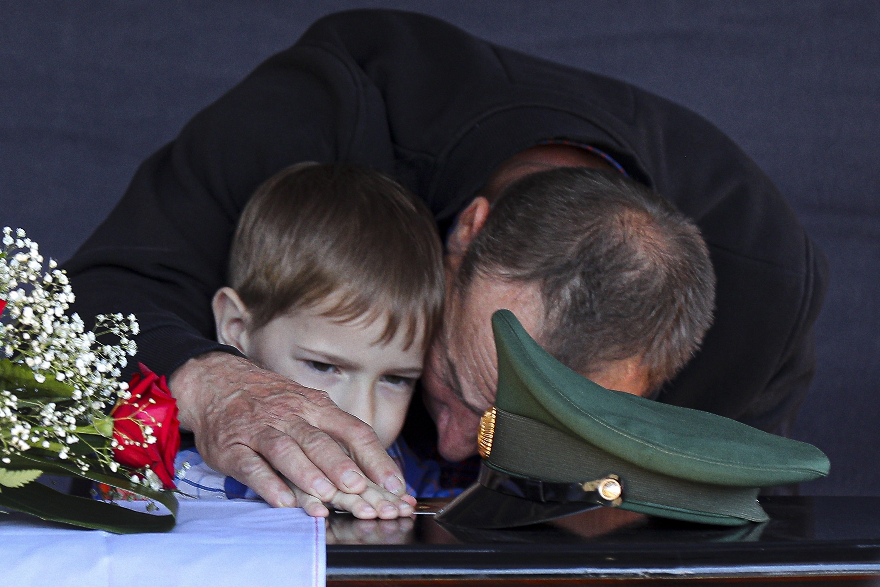 Father and son of a Russian soldier who was killed in Ukraine, mourn his death at a ceremony in Volzhsky, Russia. Photo / AP