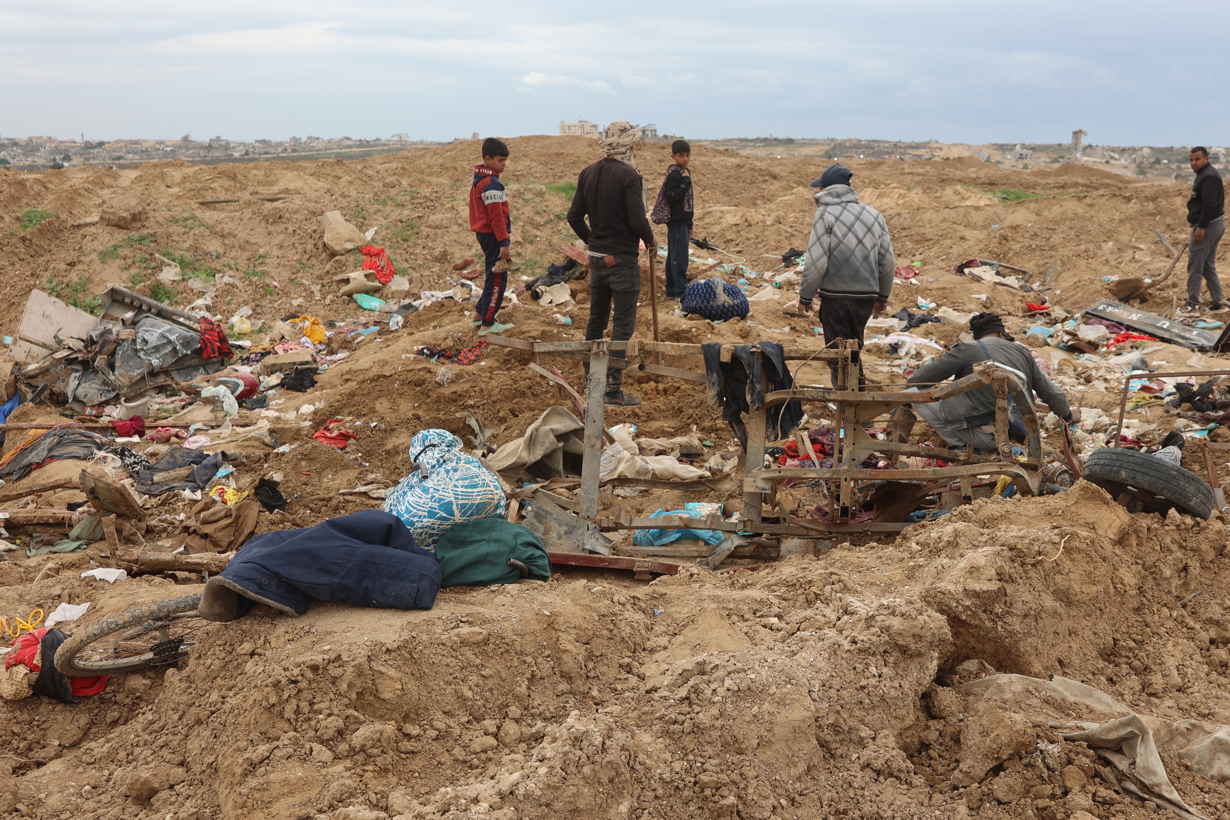 Displaced Palestinians inspect piles of clothes as they cross the Netzarim Corridor. Photo / Omar AL-QATTAA / AFP