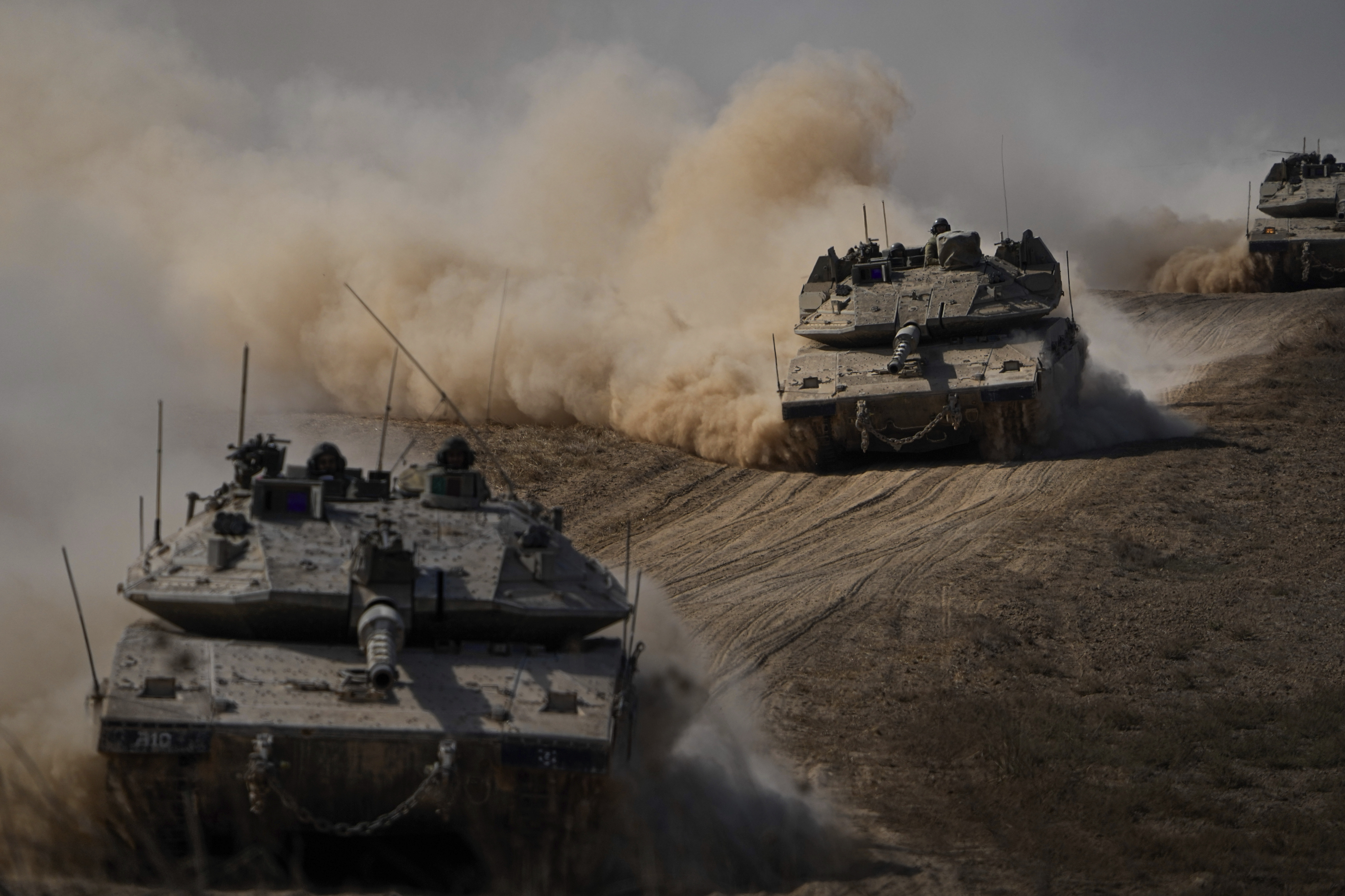 Israeli tanks head towards the Gaza Strip border in southern Israel on Friday. Photo / AP