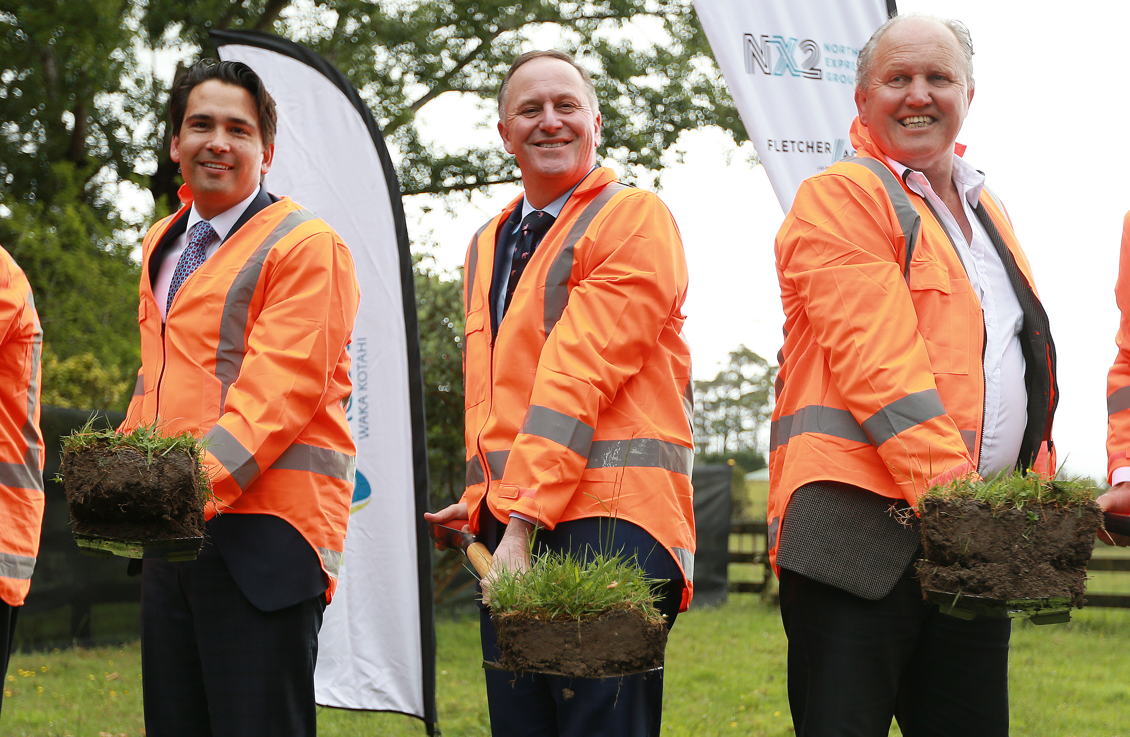 John Key, centre, turning the first sod of the Puhoi to Warkworth Motorway today, with Simon Bridges, left. Photo / Doug Sherring