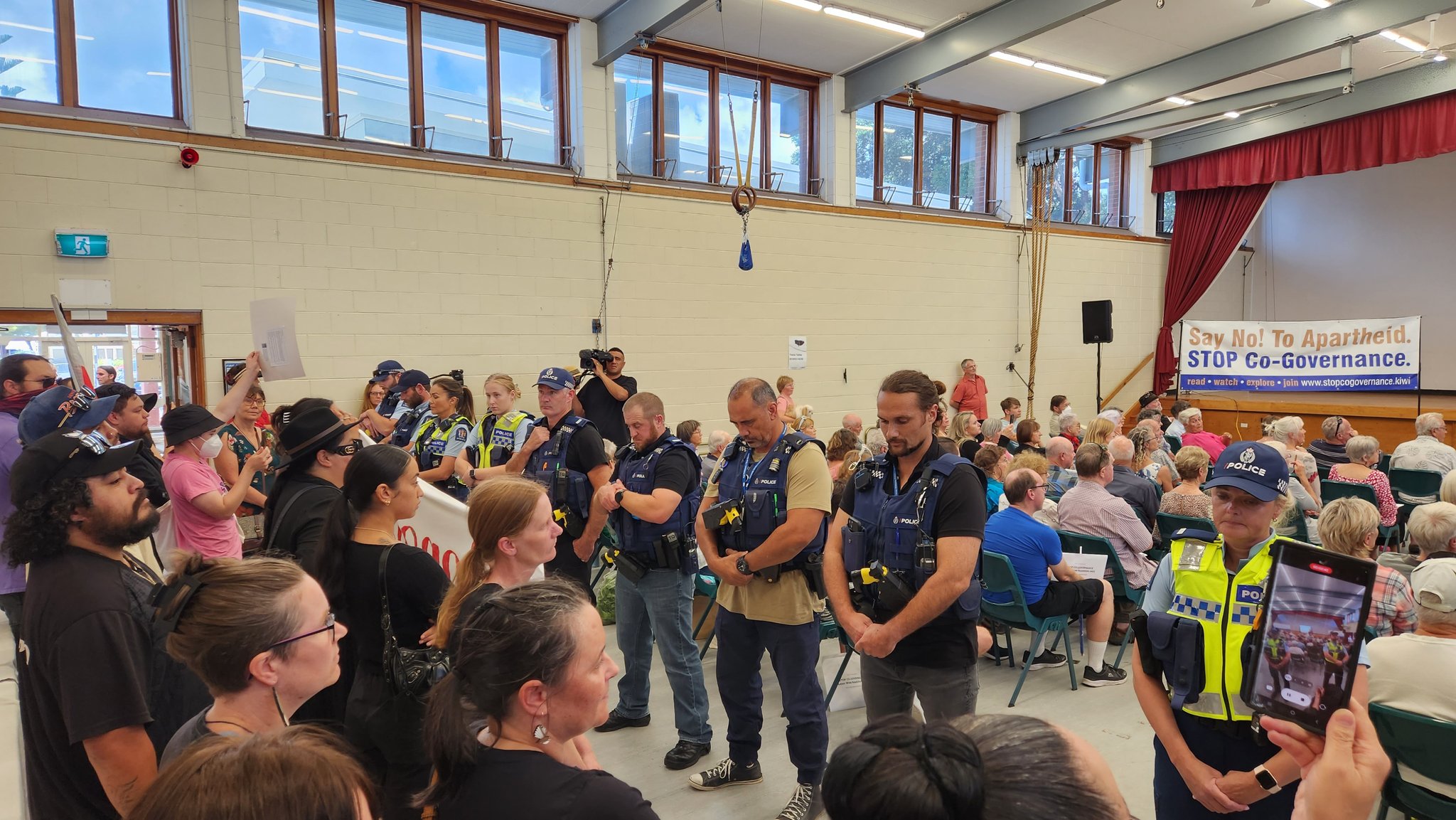 Police separate protestors at the Ōrewa leg of Julian Batchelor's 'Stop Co-Governance' tour. Photo / Jake Law