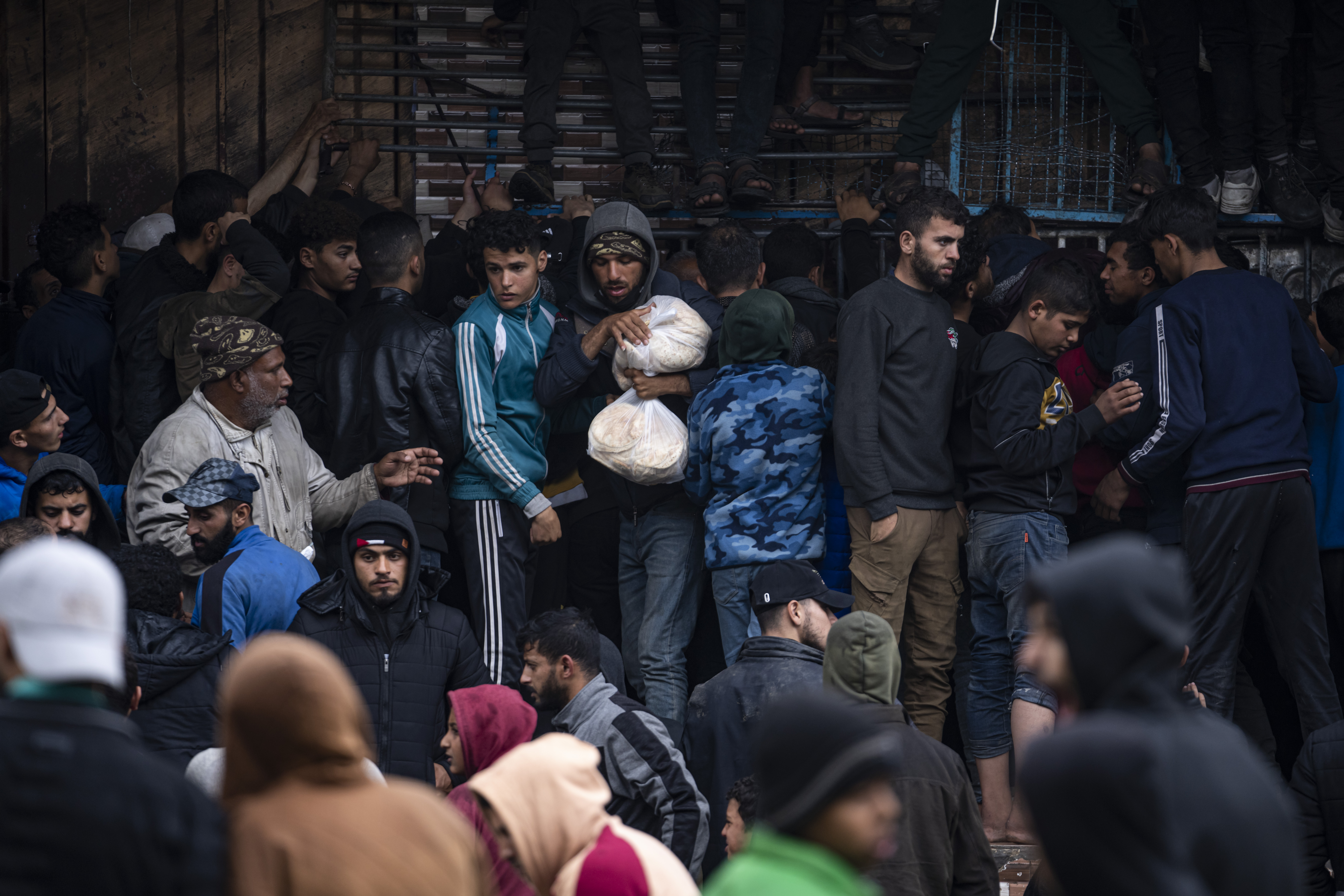 Palestinian crowds struggle to buy bread from a bakery in Rafah, Gaza Strip. Photo / AP