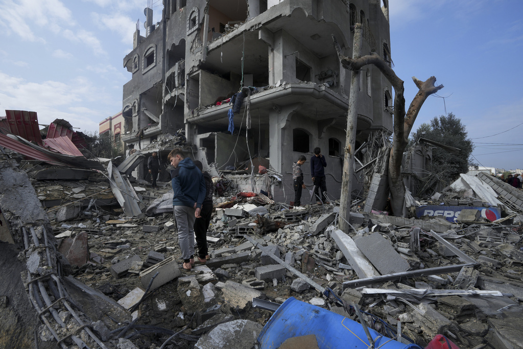 Palestinians inspect the rubble of a building of the Al Nawasrah family destroyed in an Israeli strike in Maghazi refugee camp, central Gaza Strip on December 25. Photo / AP