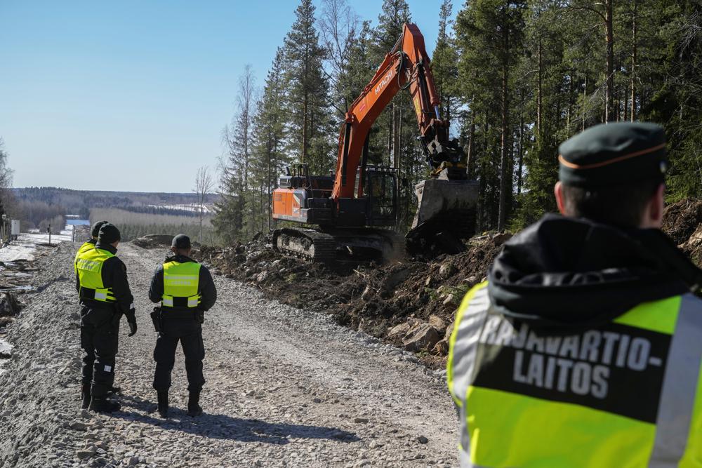Finnish border guards stay at construction site of the border barrier fence between Finland and Russia near Pelkola border crossing point in Imatra, south-eastern Finland. Photo / AP