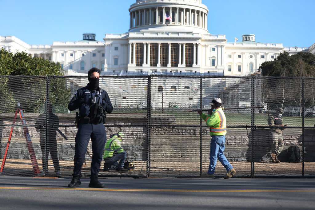 Workers erect a fence around the US Capitol Building today. Photo / Getty Images